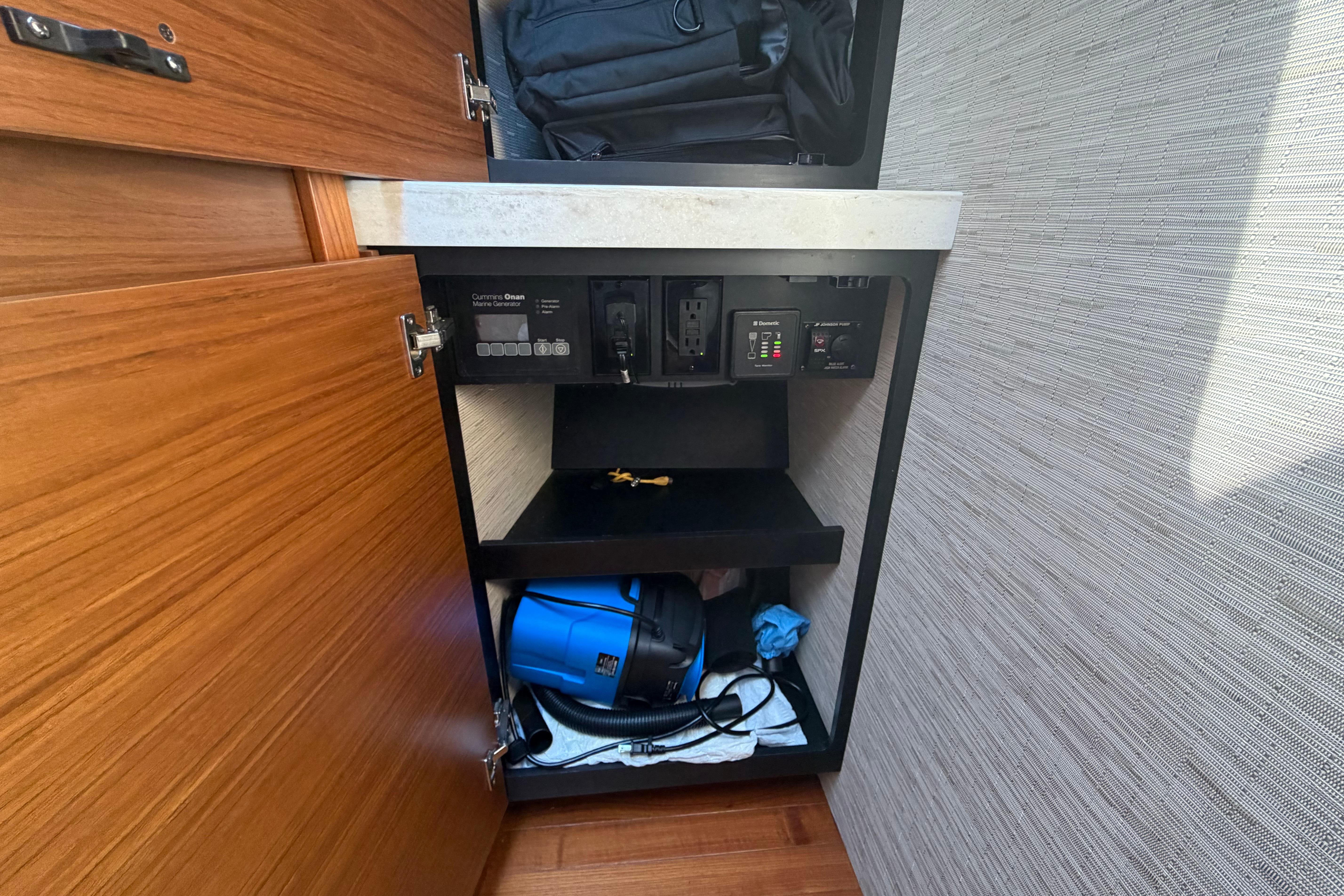 2016 Tiara Yachts C39 Coupe interior cabinet with storage and electrical panel.