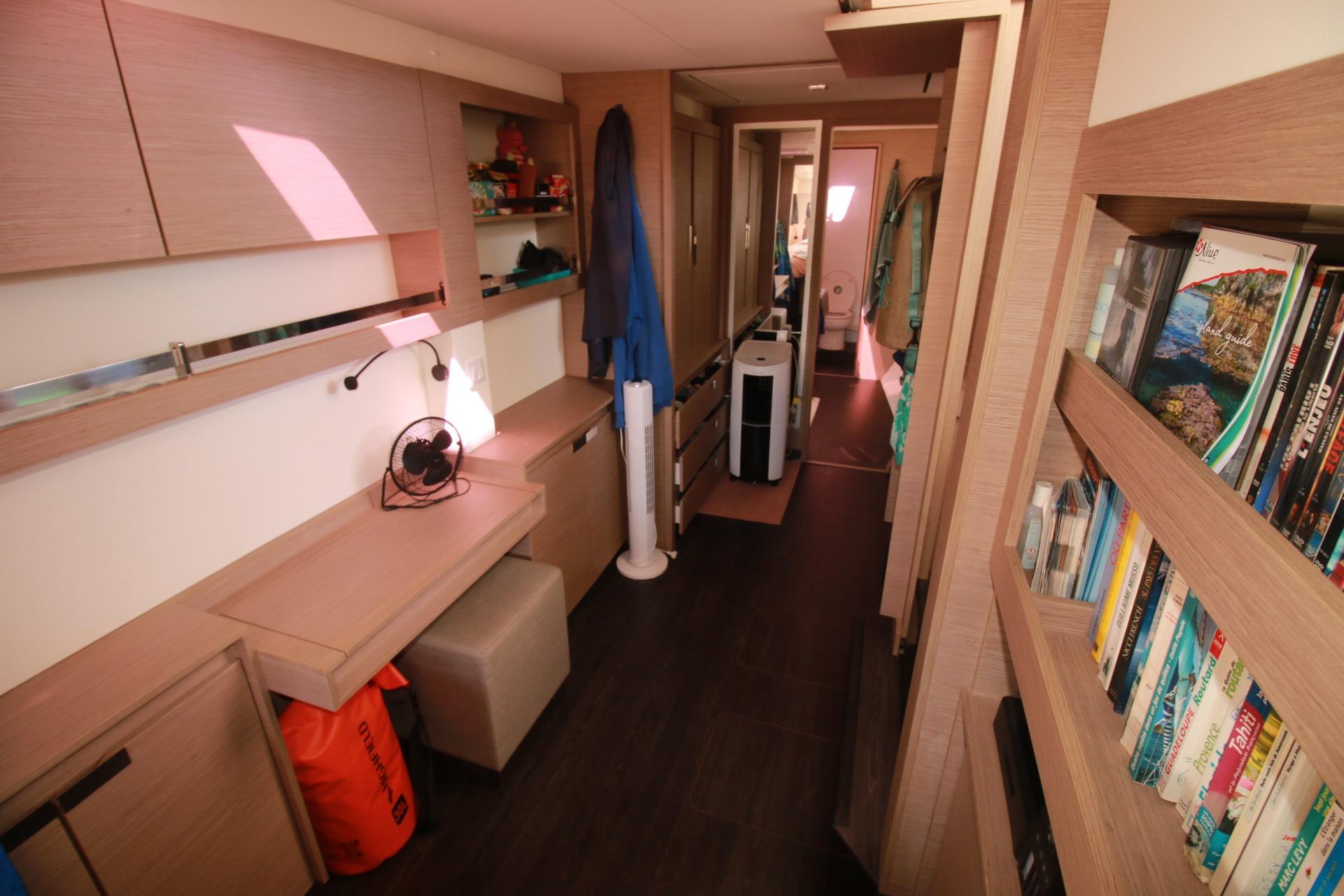 Interior of 2022 Fountaine Pajot Elba 45 Catamaran with bookshelves and desk area.