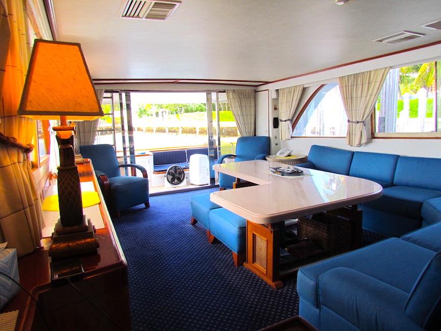 Interior of 1972 Hargrave 67 Motor Yacht with blue seating and elegant decor.