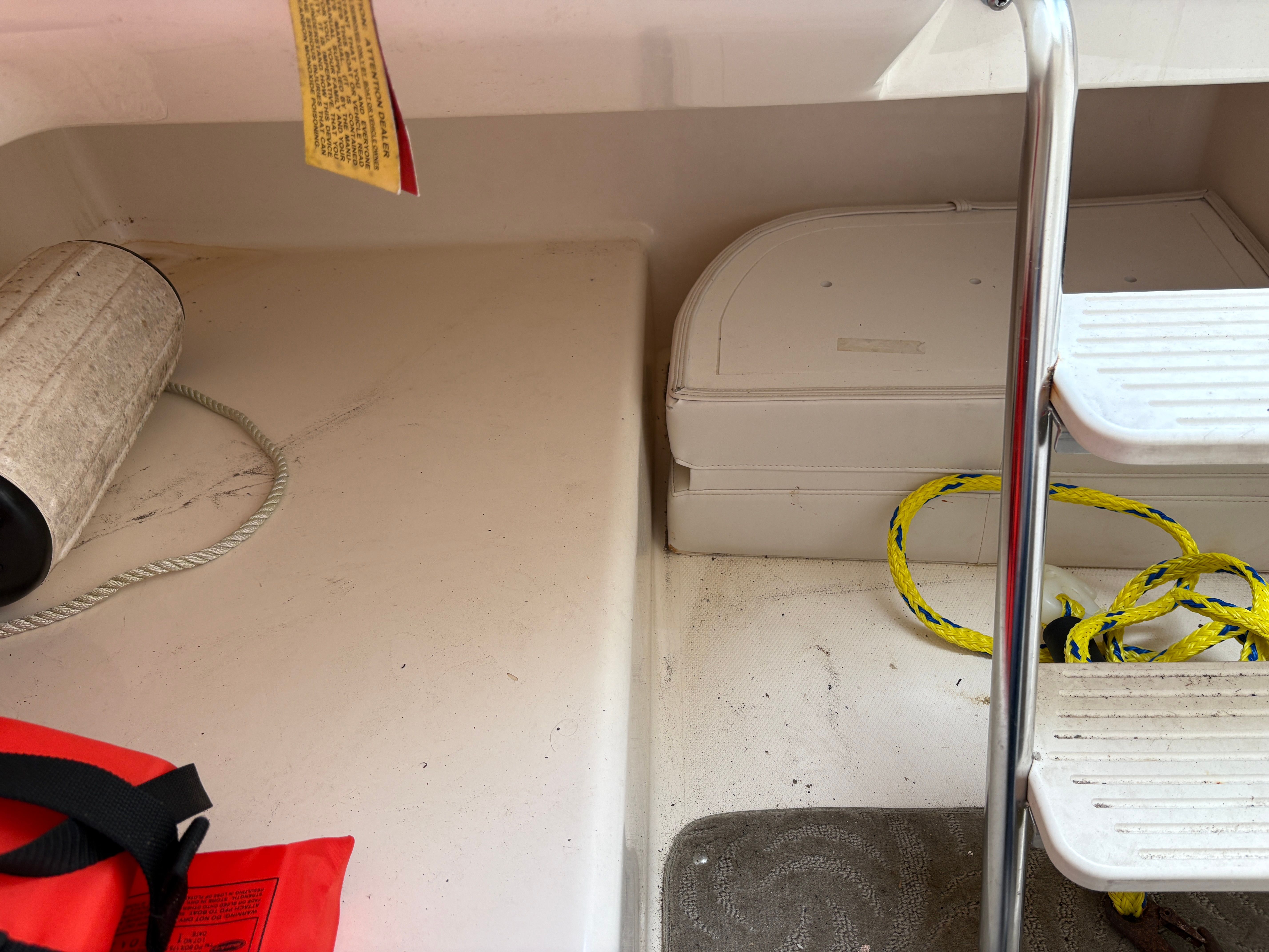 Interior of a 2009 Hurricane SUN DECK 260 boat with rope and steps.