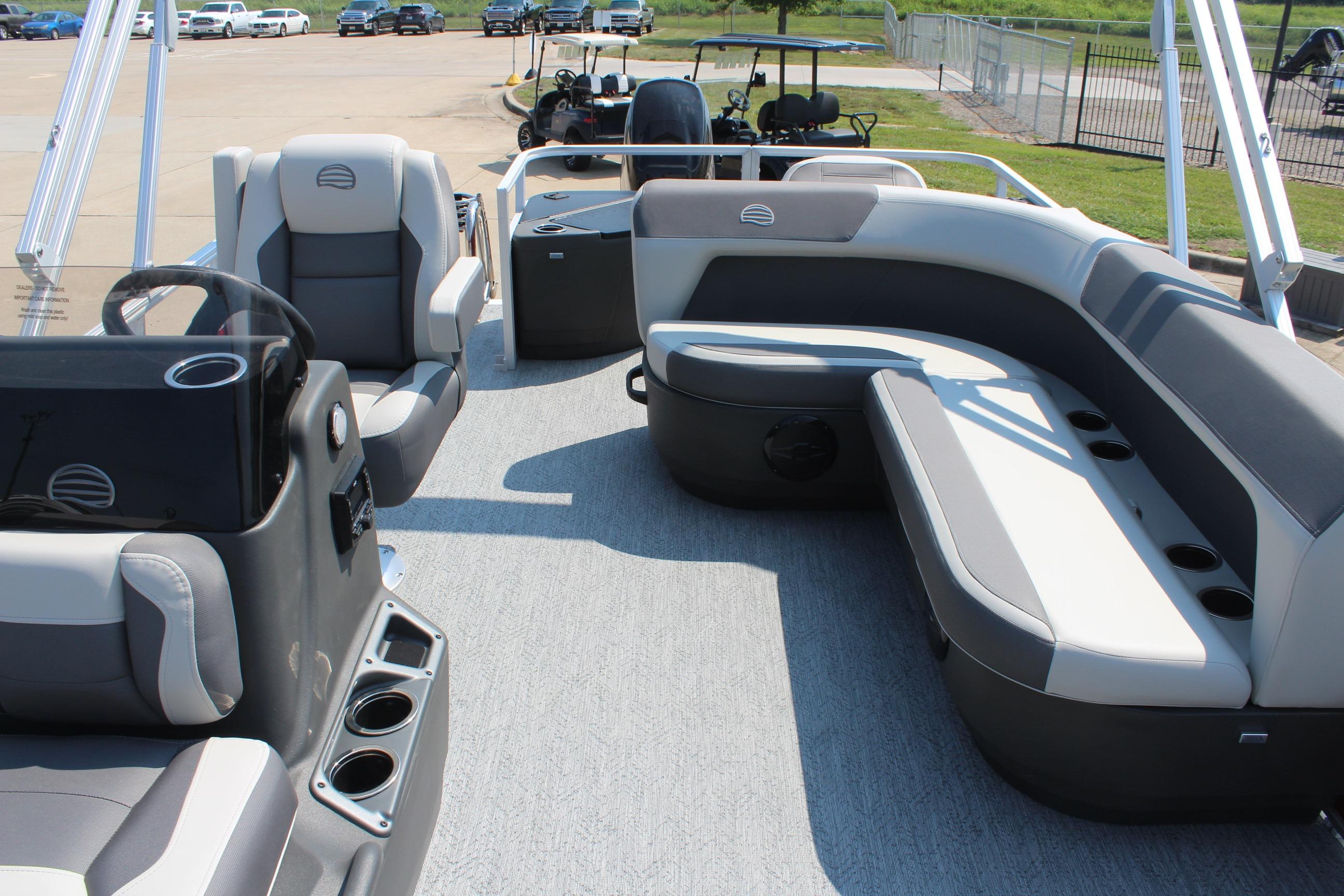 2026 Sun Tracker Bass Buggy 18 DLX pontoon boat interior with seating and steering console.