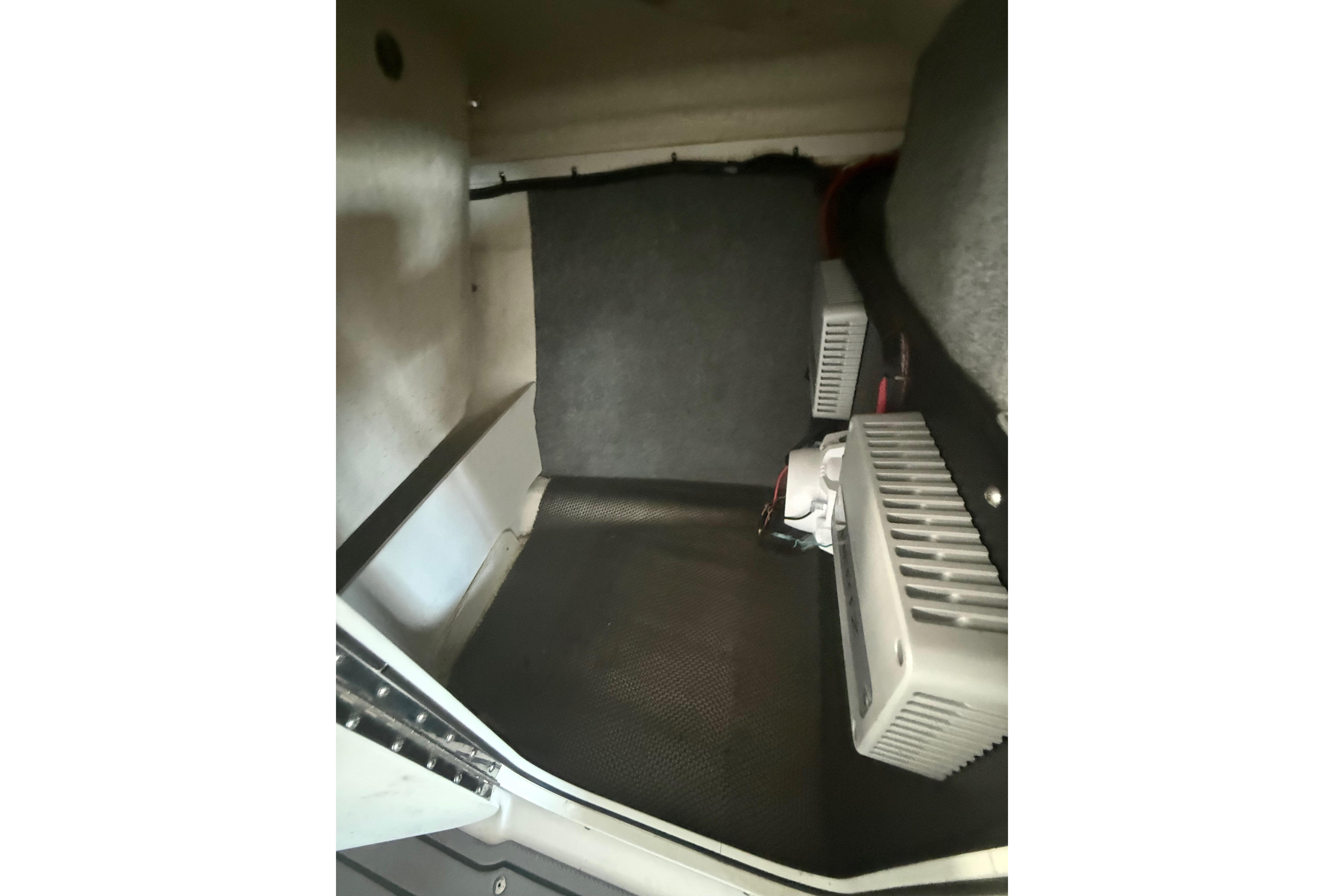 Interior view of 2023 Chaparral 230 SSi boat storage compartment.
