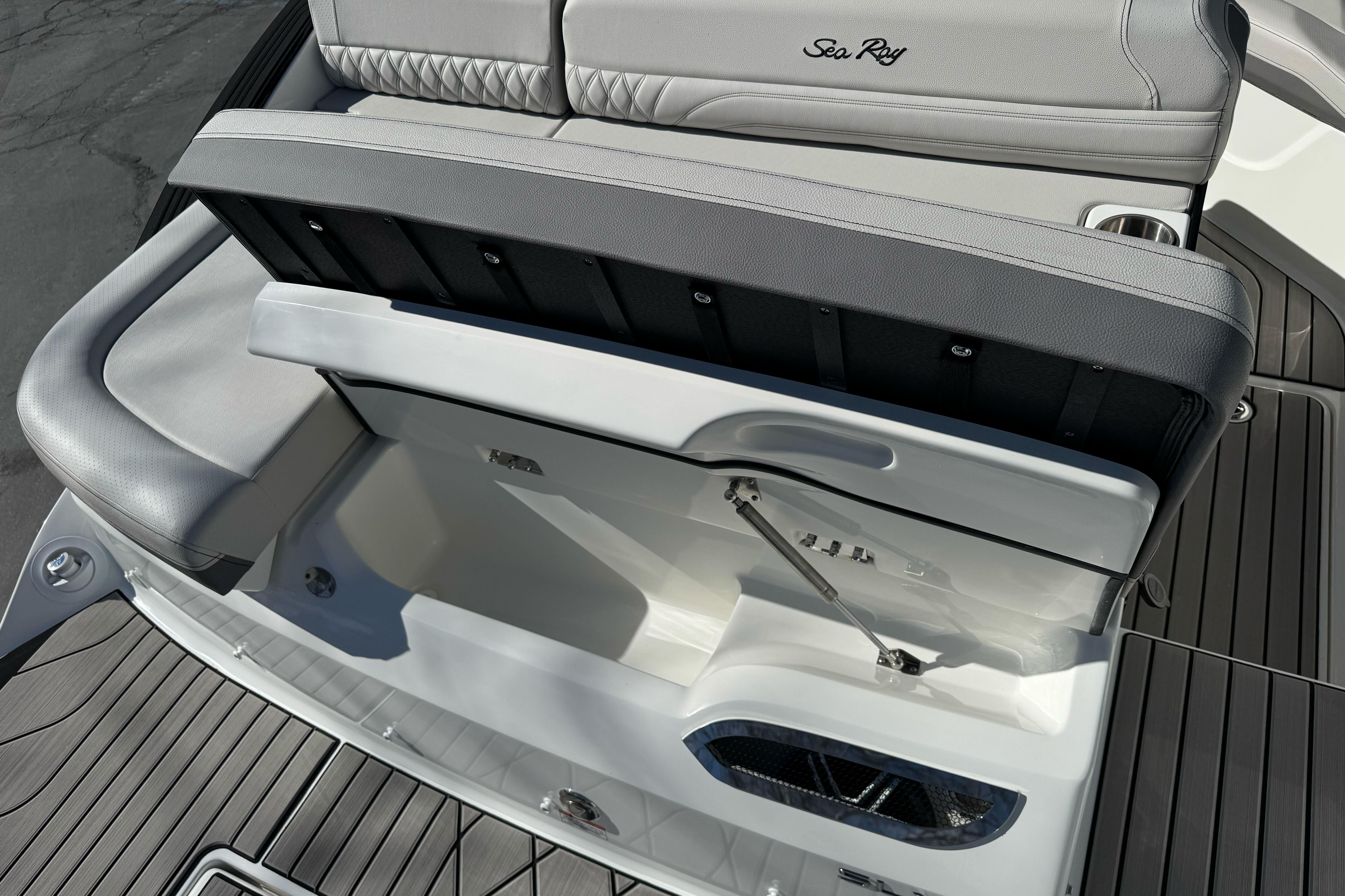 2026 Sea Ray SLX 260 boat seating with storage compartment open.