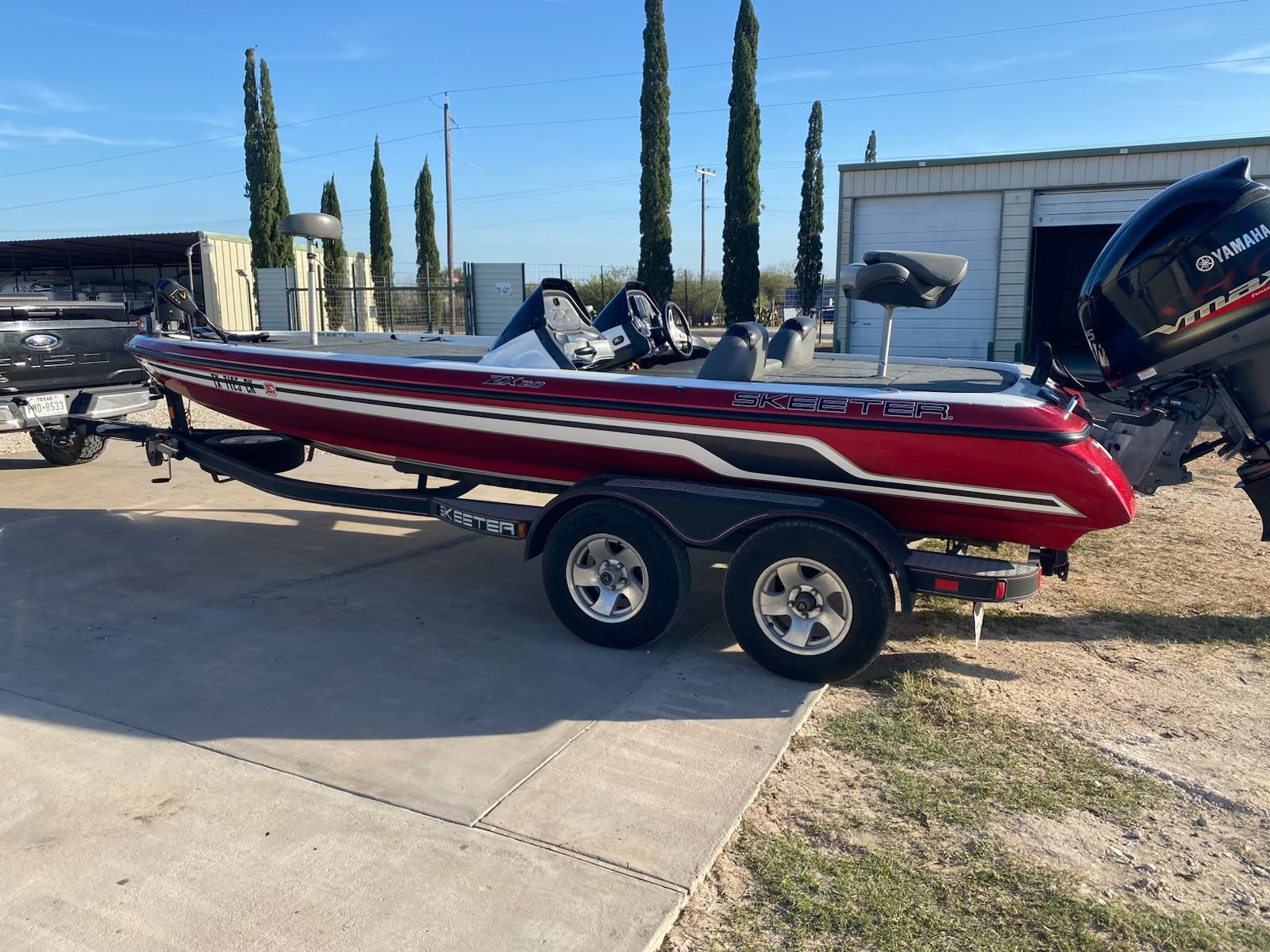 2012 Skeeter ZX20 boat on trailer, red design, Yamaha engine.
