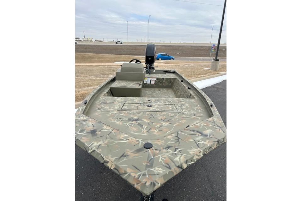 2026 Tracker Grizzly 1648 SC boat with camouflage design on a paved surface.