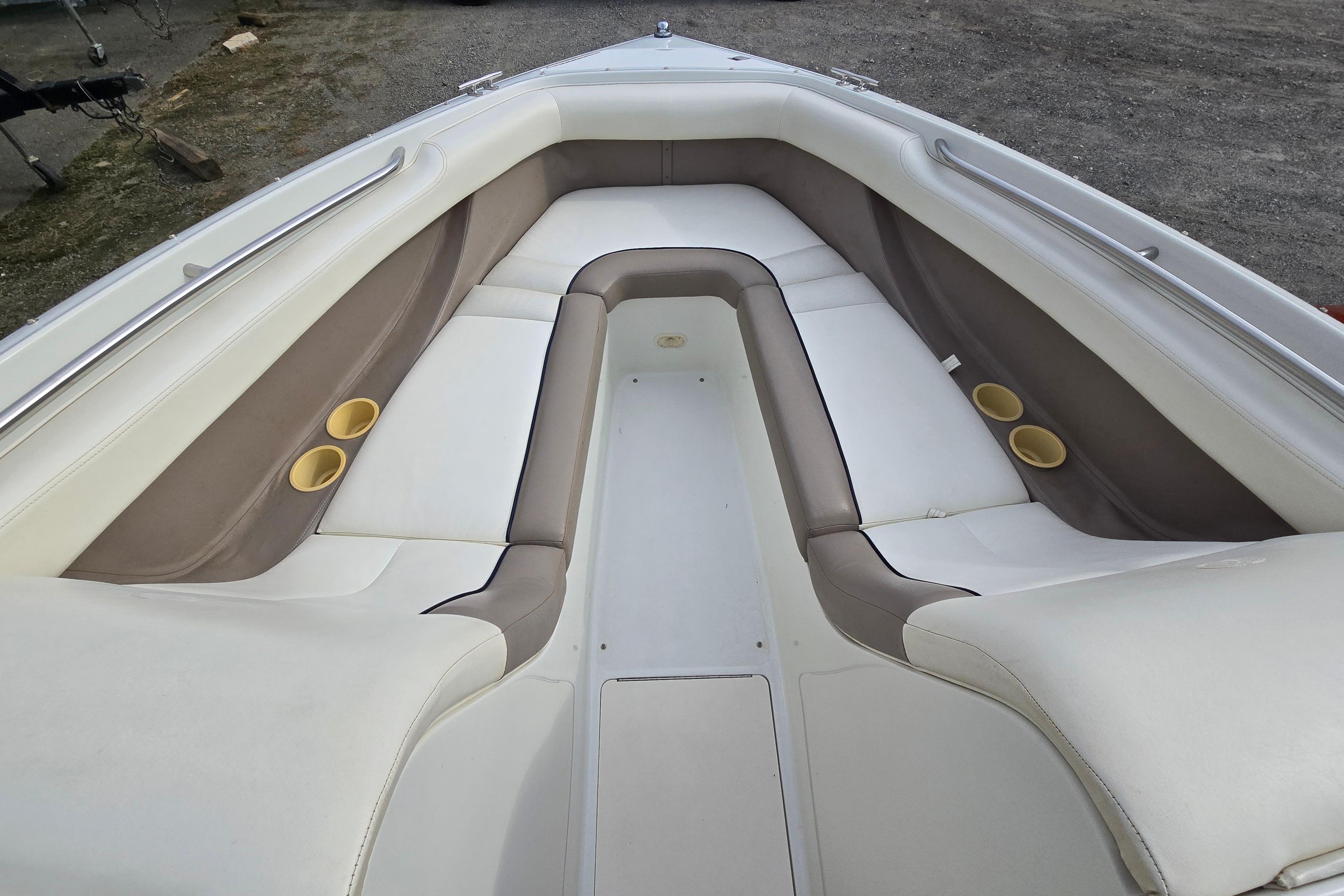Interior of a 2000 Cobalt 246 boat with cushioned seating and cup holders.