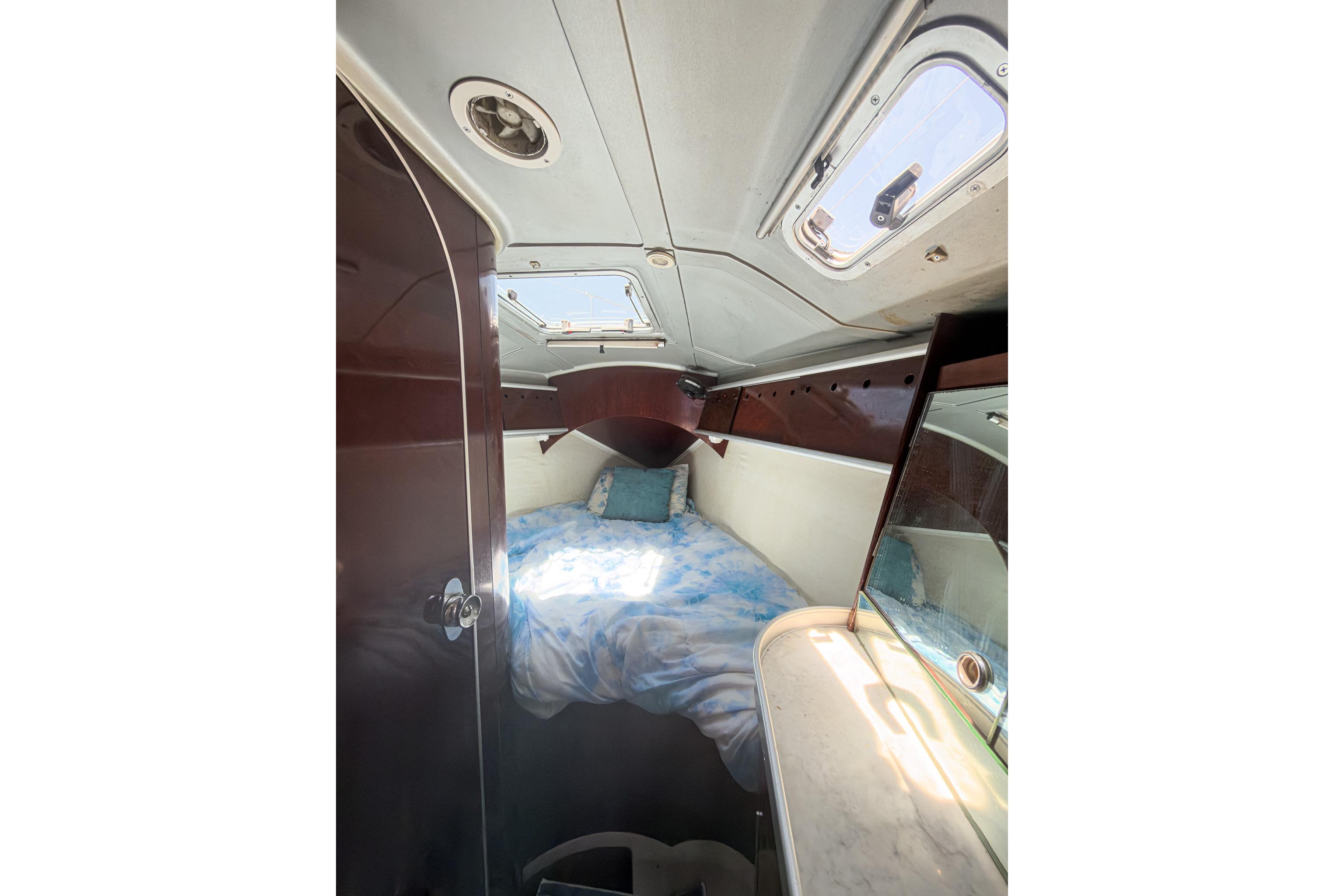 Cozy cabin interior of 1993 Beneteau First 38 s5 sailboat with skylight and bedding.