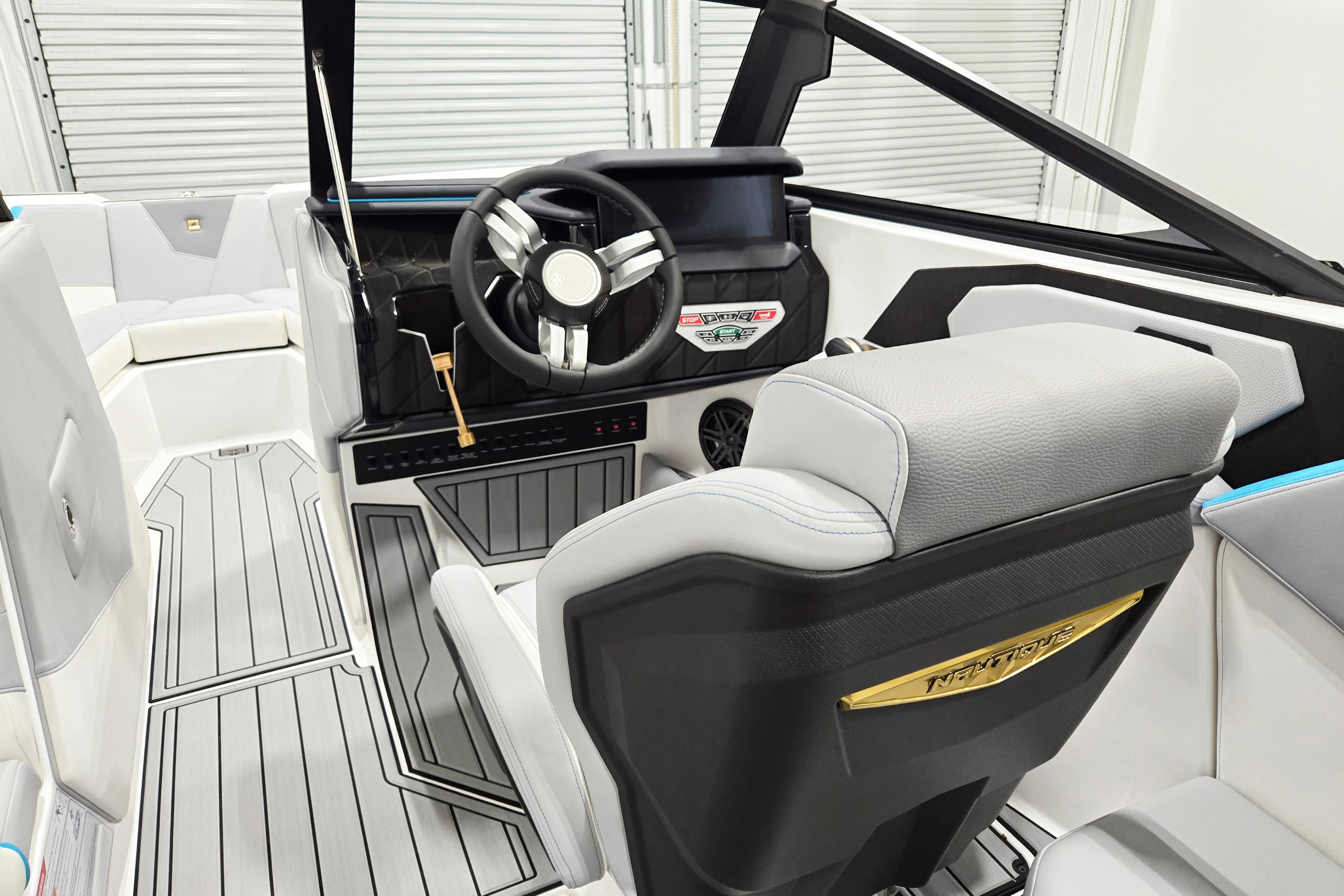 Interior of 2026 Nautique Super Air Nautique S21 boat, featuring modern steering and seating.