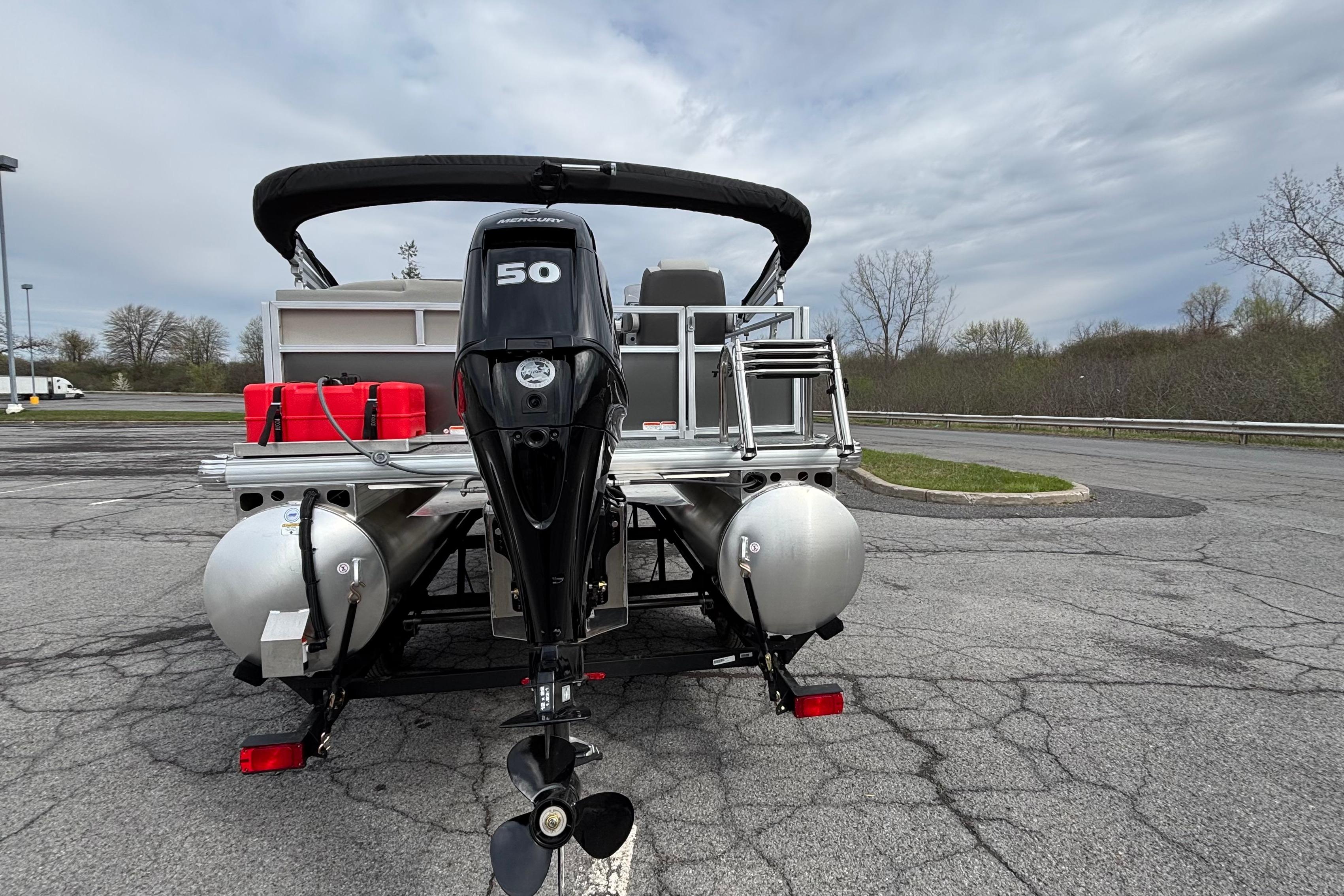 2026 Sun Tracker Bass Buggy 16 XL Select pontoon boat with 50 HP Mercury engine.