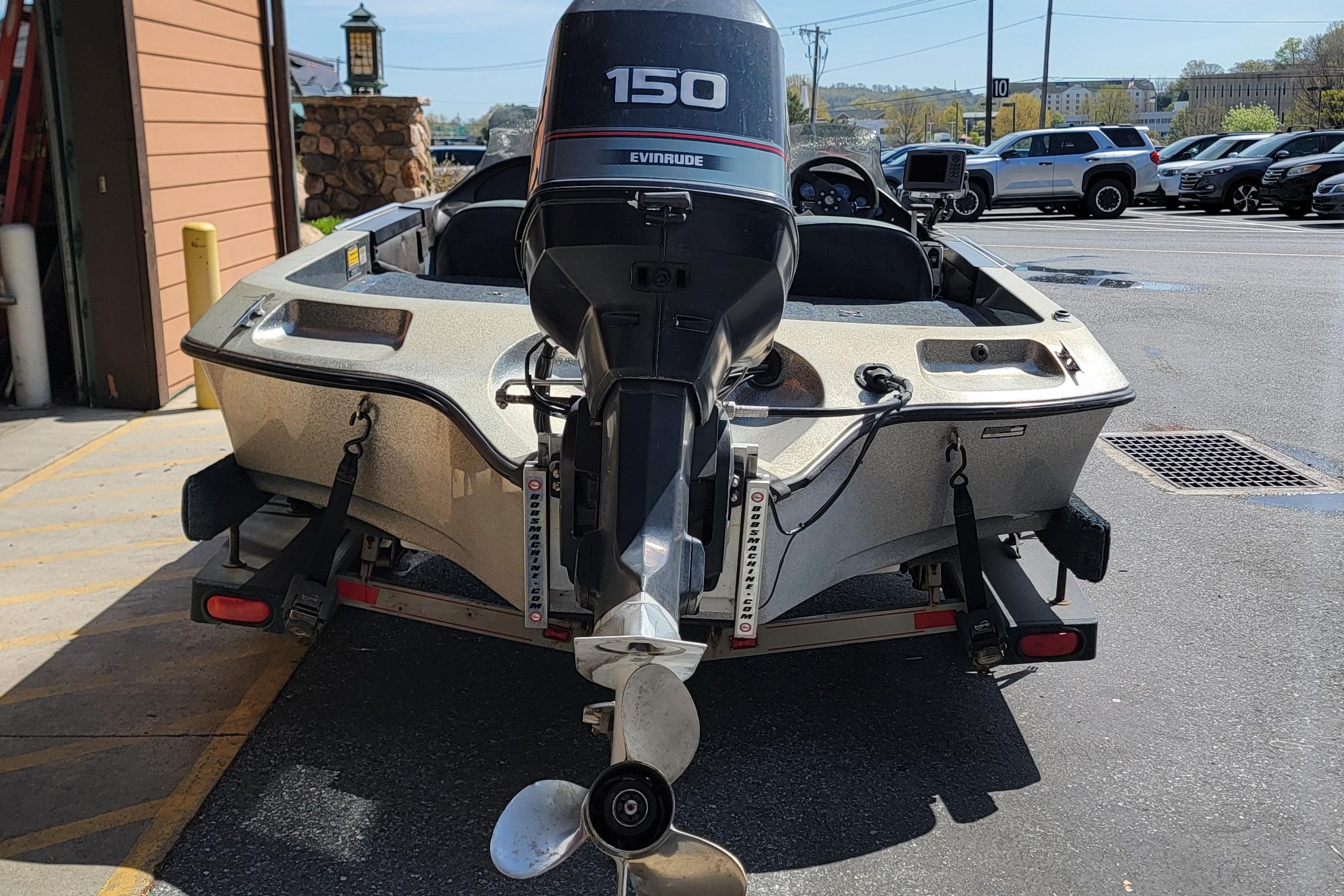 1995 Ranger boat with Evinrude 150 outboard motor, parked on a trailer.