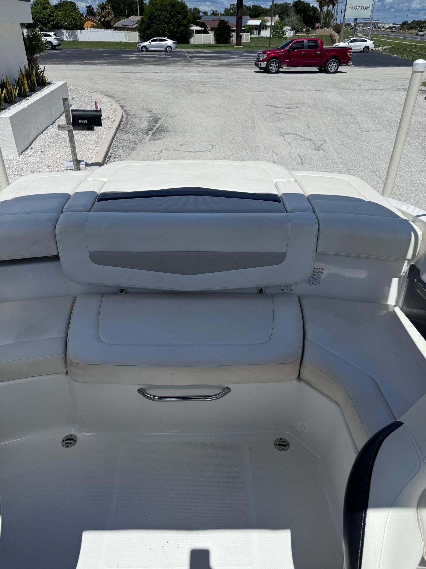 The image shows the stern of a 2013 Chaparral 206 SSi boat with white upholstery.