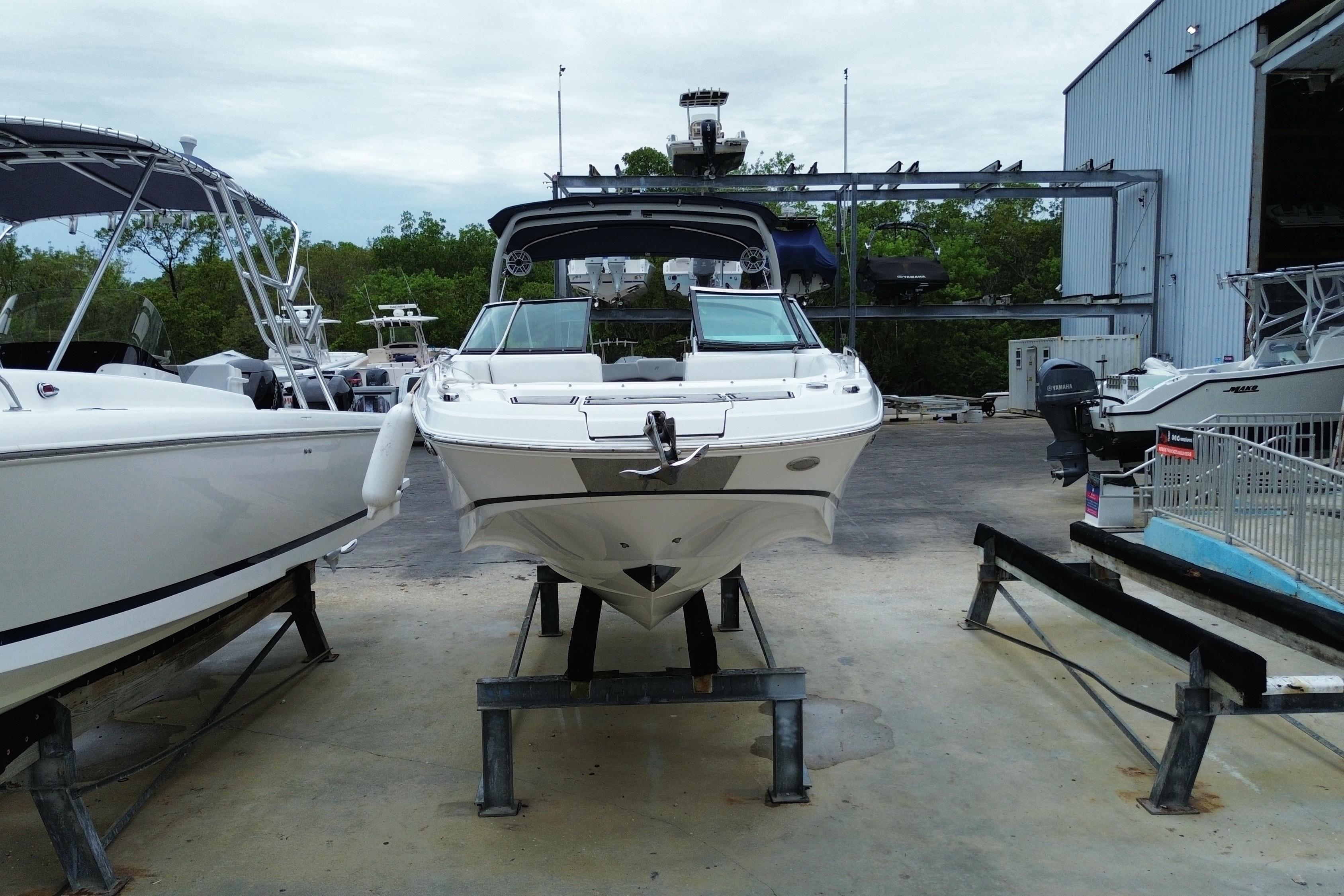 2022 Four Winns HD8 OB boat on display at a marina, surrounded by other vessels.