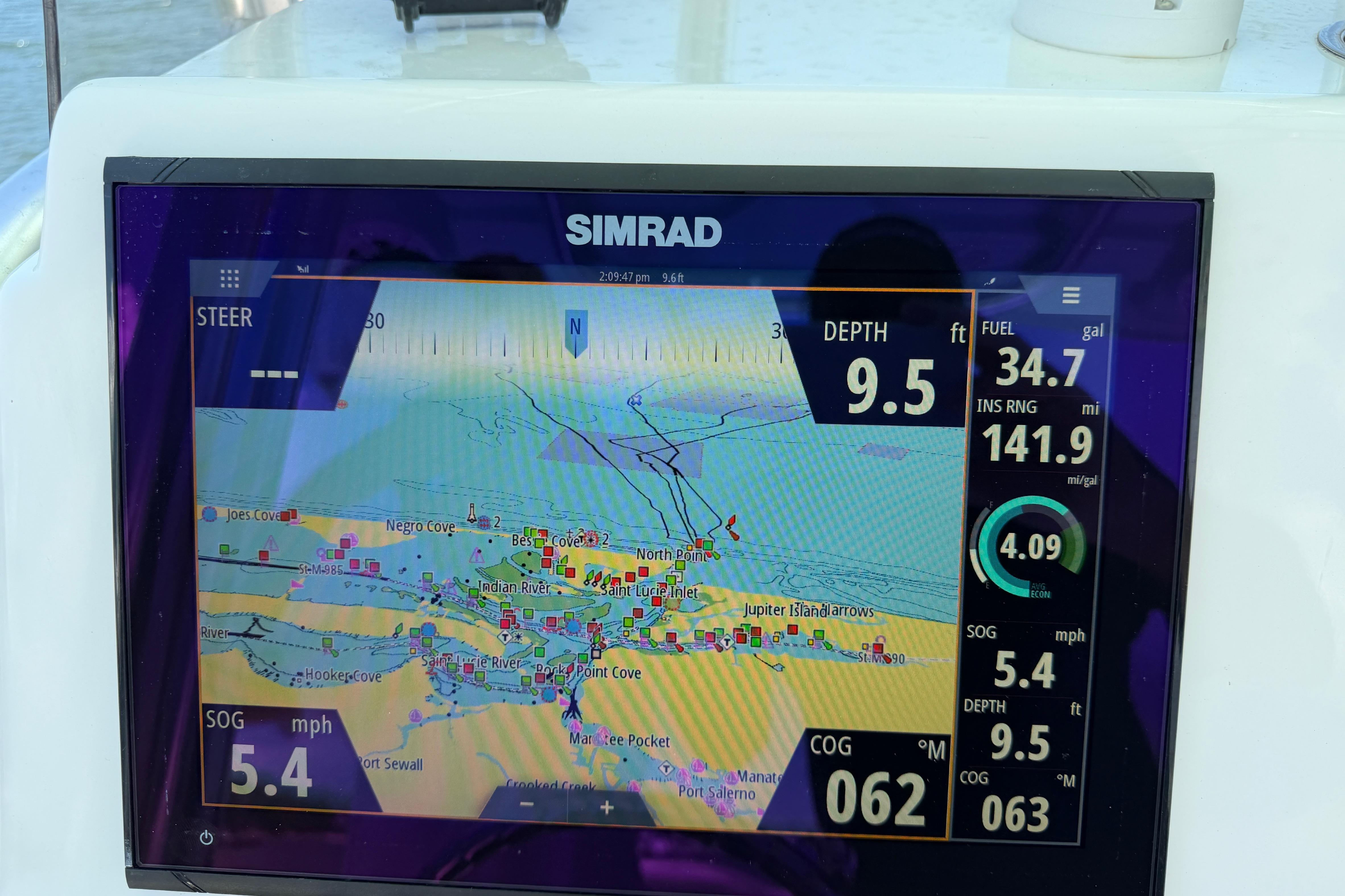 Simrad navigation display on 2022 Aquasport 230 Pro Bay, showing map and boat metrics.