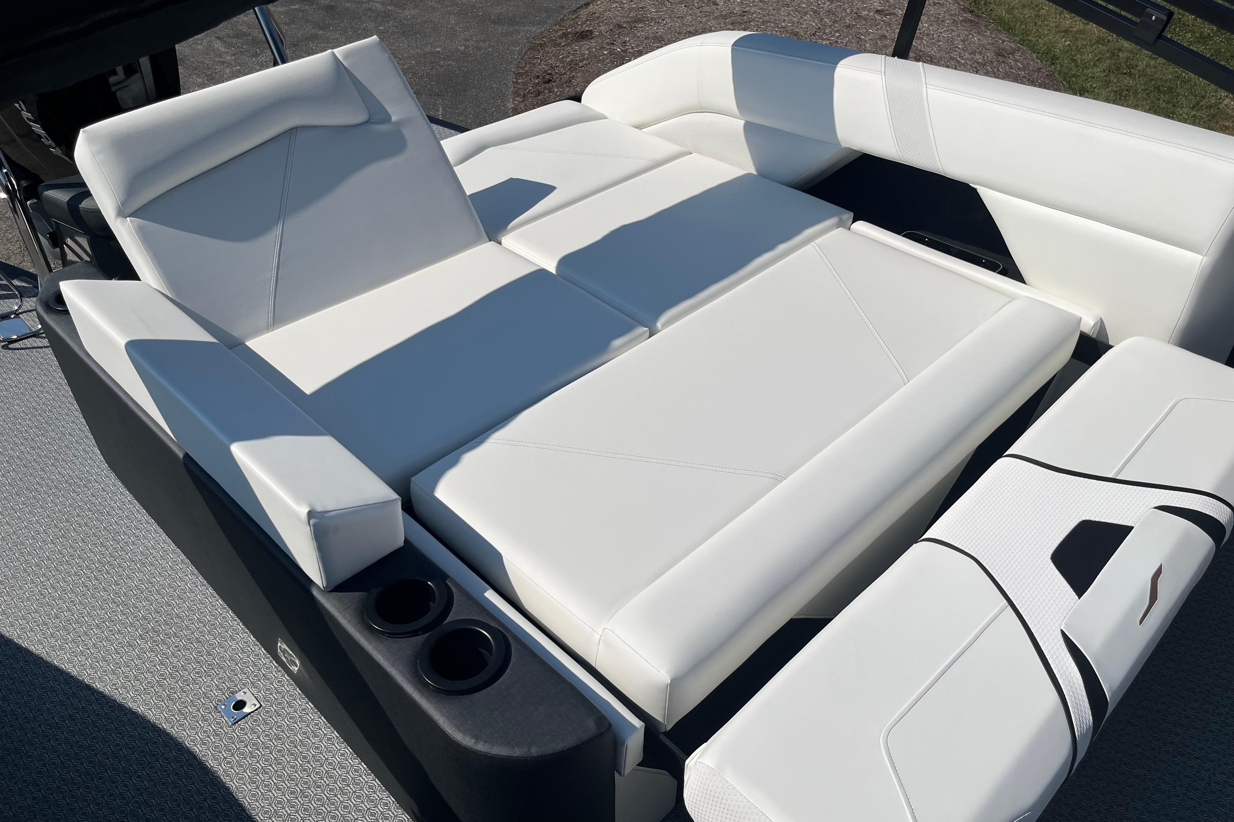 Luxurious white seating on 2026 Evotti 725CS boat, featuring cup holders and modern design.
