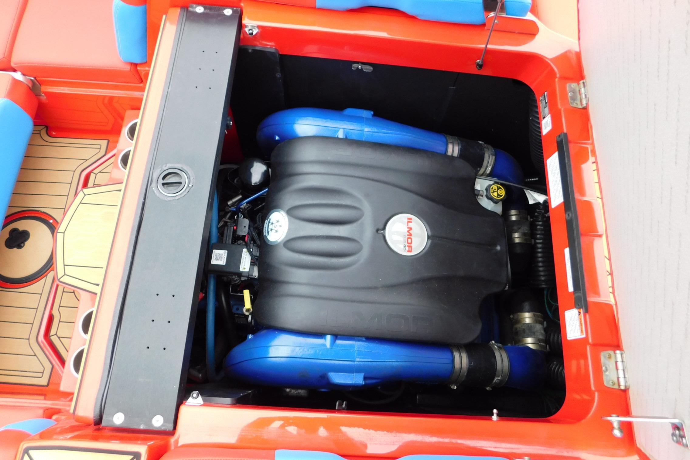 Engine compartment of 2022 MasterCraft NXT24 boat with Ilmor engine, red and blue accents.