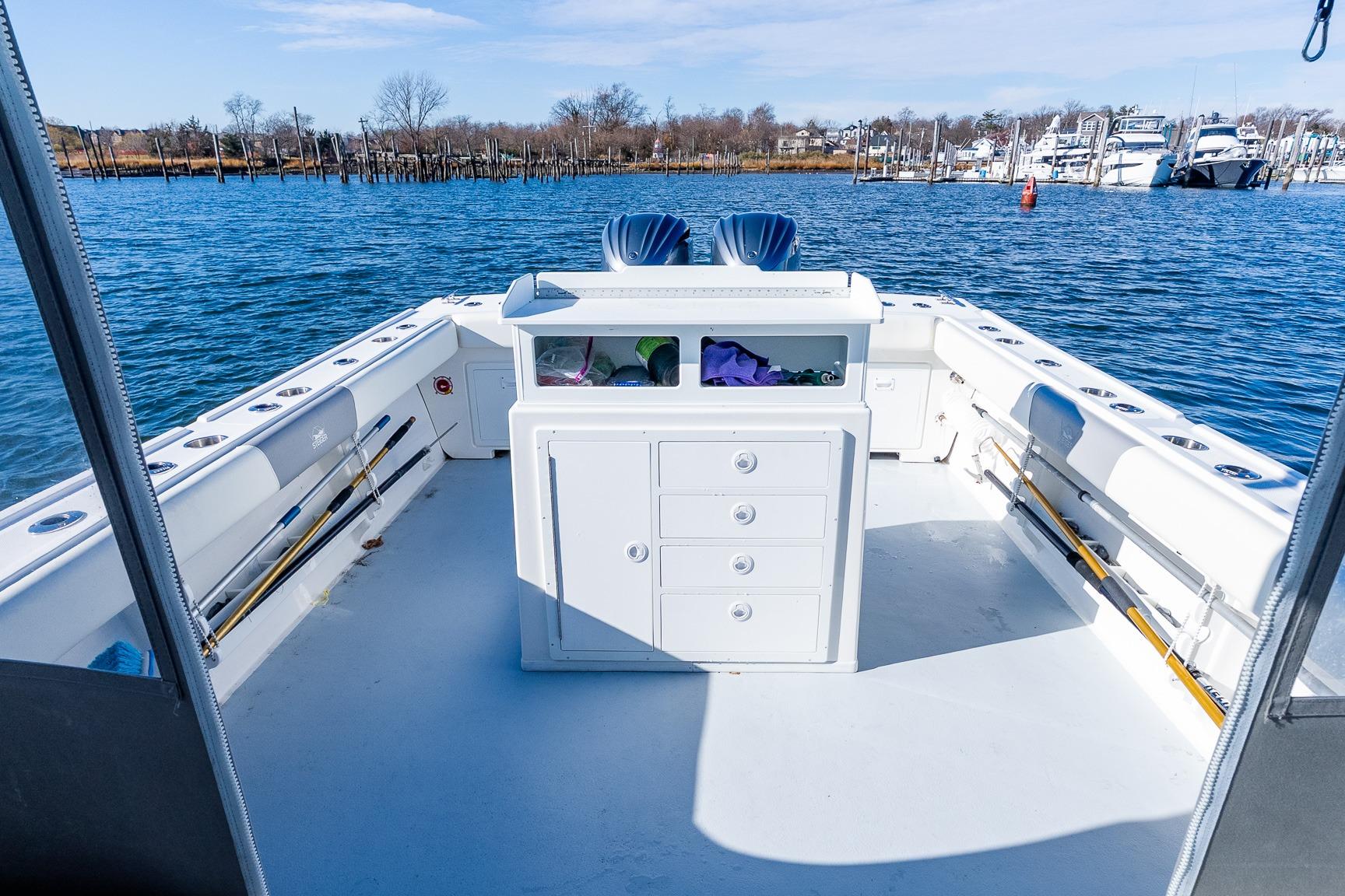 2024 Steiger Craft 31 Fisherman boat deck with storage and fishing rods.