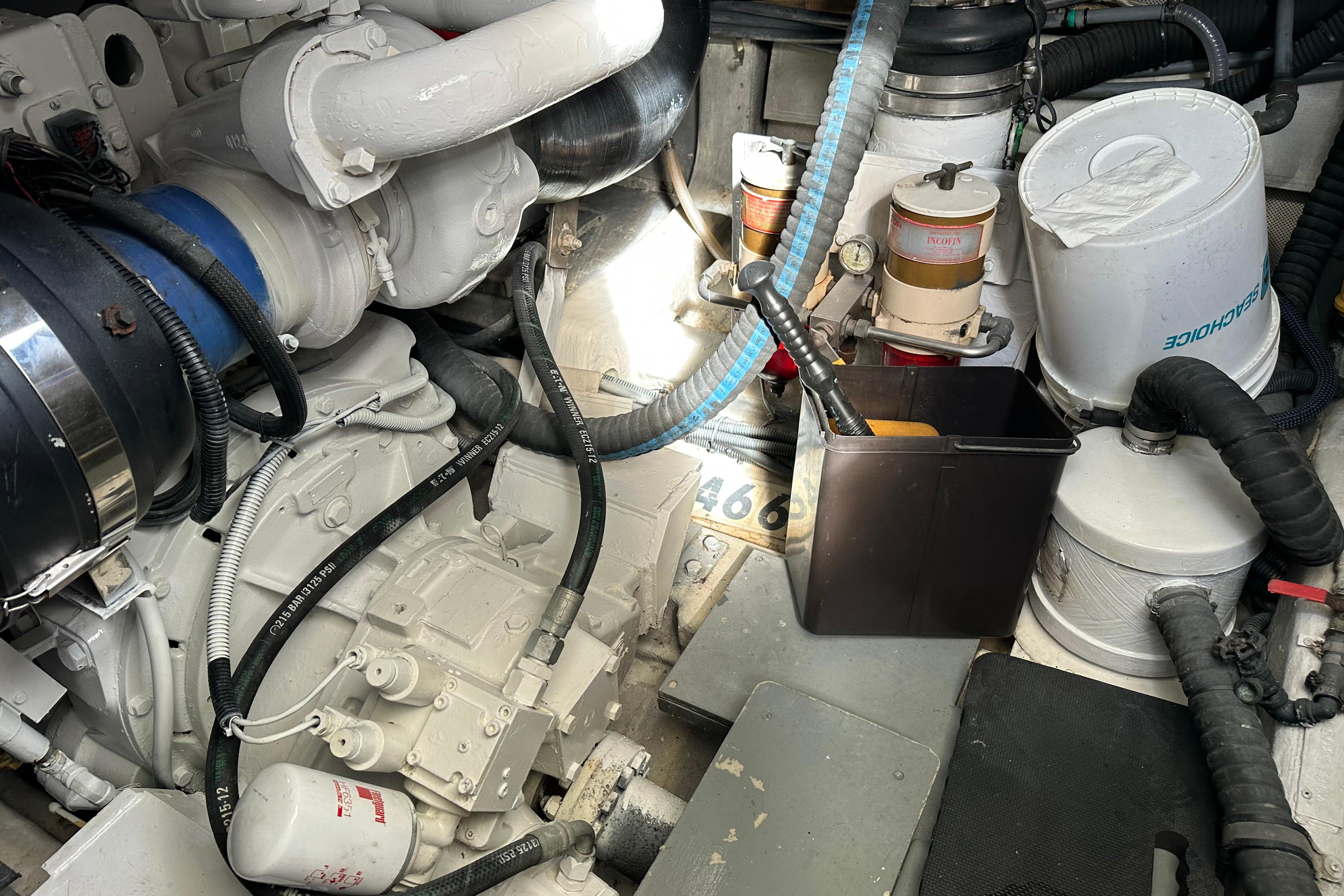 Engine room of a 2004 Azimut 55E yacht, showcasing mechanical components and filters.