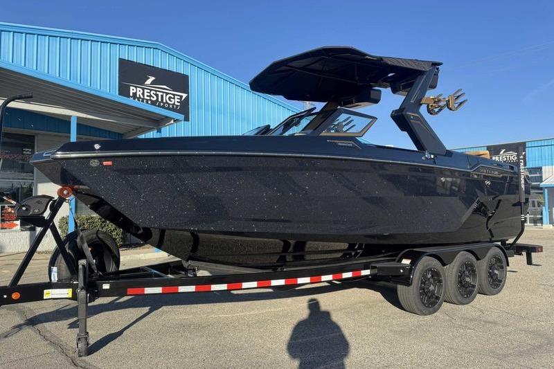2026 MasterCraft XStar 25 boat on trailer at Prestige Water Sports dealership.
