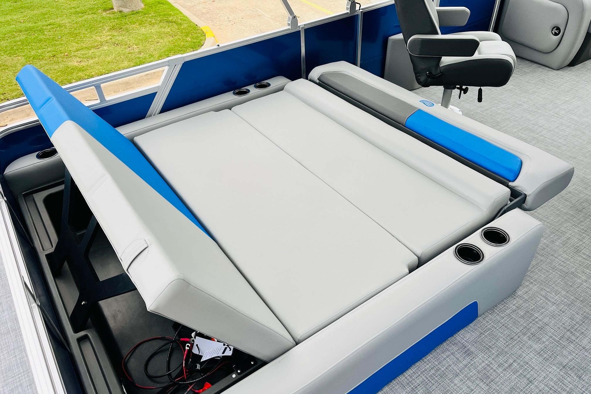 2026 Sun Tracker Party Barge 22 RF DLX interior with adjustable seating and cup holders.