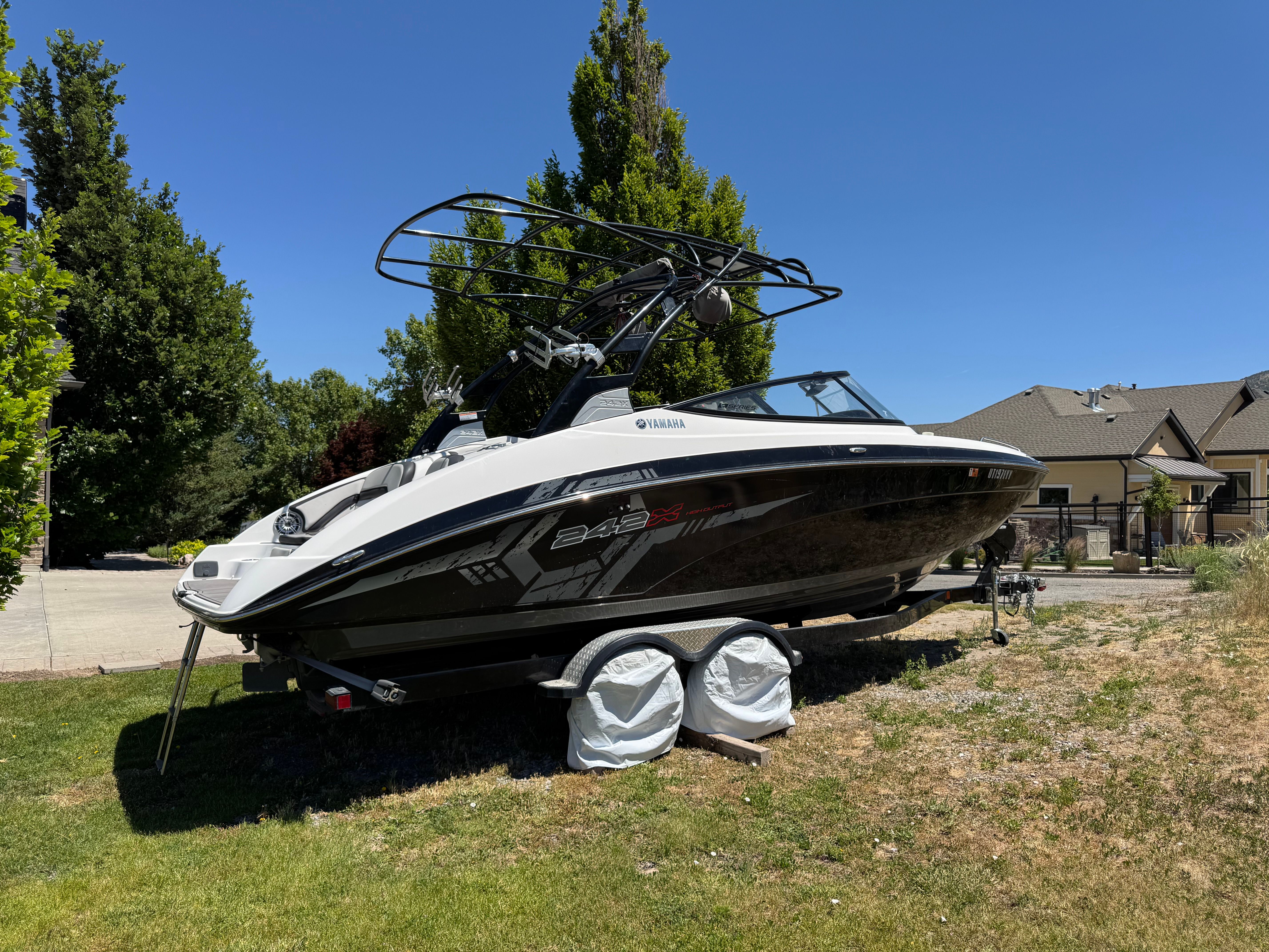 A 2017 Yamaha 242X E-Series boat on a trailer outdoors.