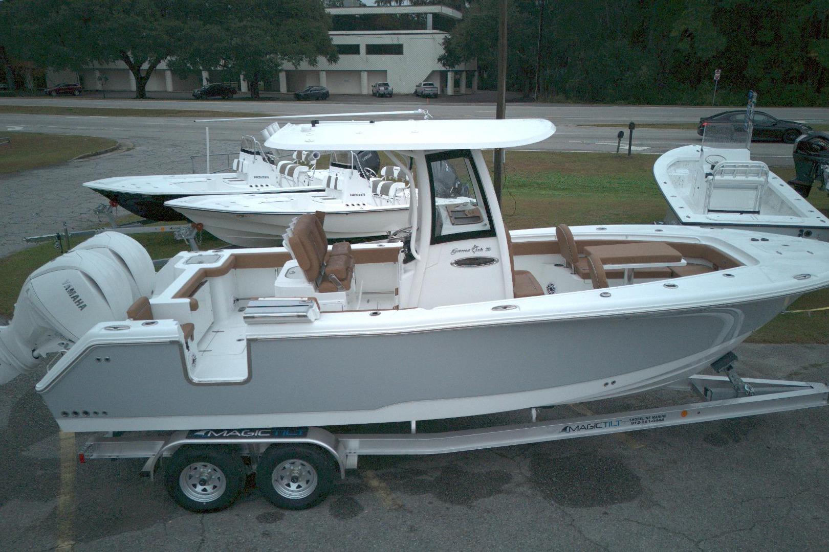 2026 Sea Hunt Gamefish 25 boat on trailer, featuring sleek design and Yamaha engine.