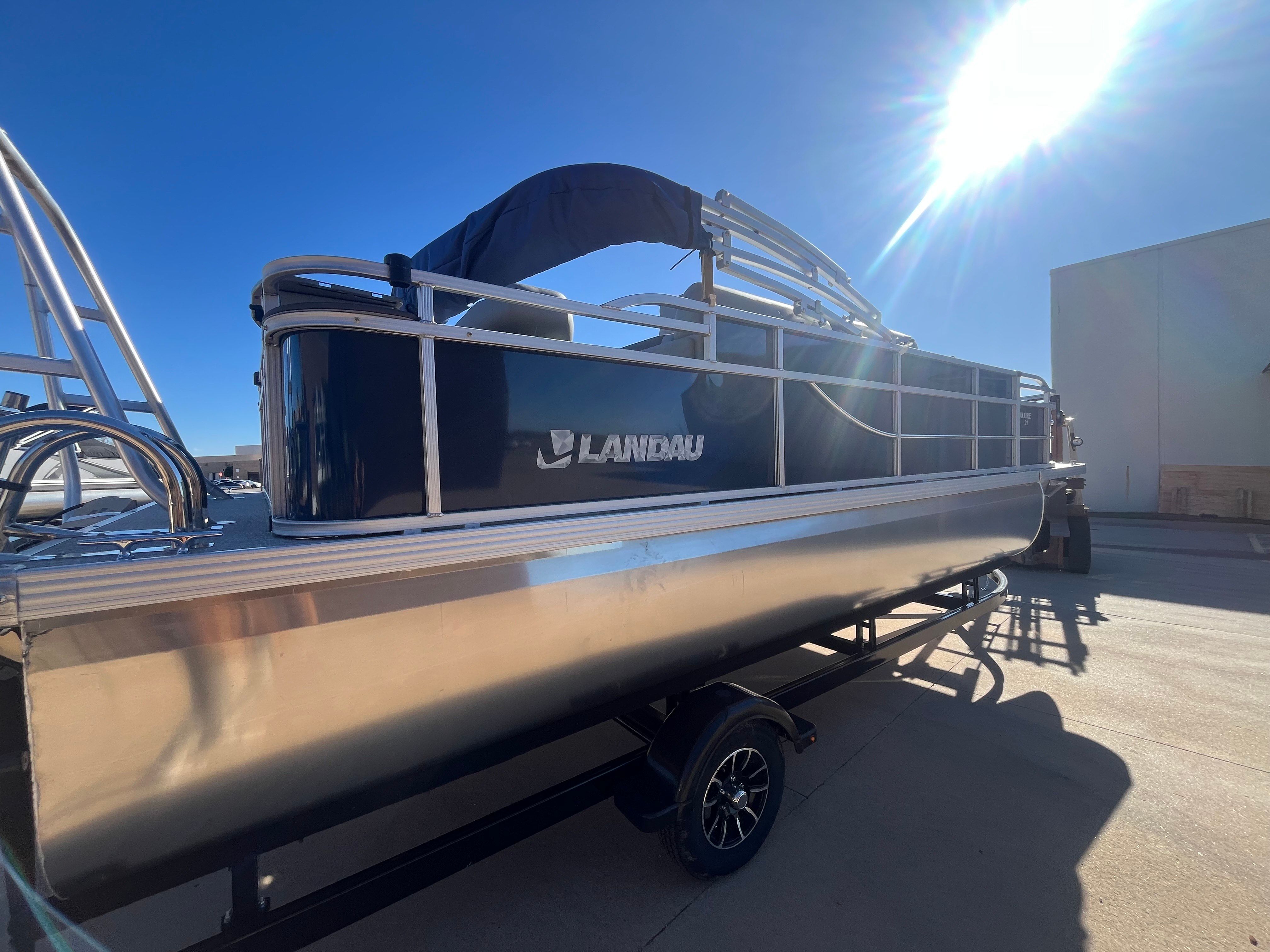 2026 Landau Alure 21CC Fish pontoon boat in sunlight.