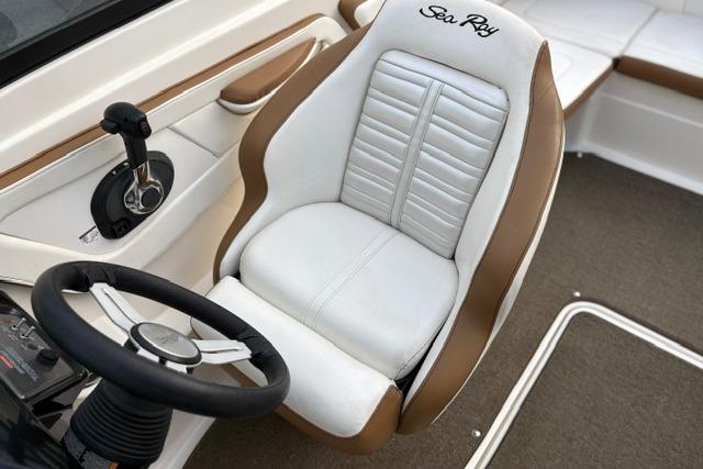 2017 Searay SPX210 boat interior with white and brown captain's seat and steering wheel.