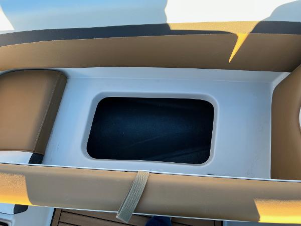 2024 Starcraft SVX 191 boat storage compartment with brown cushioned seating.