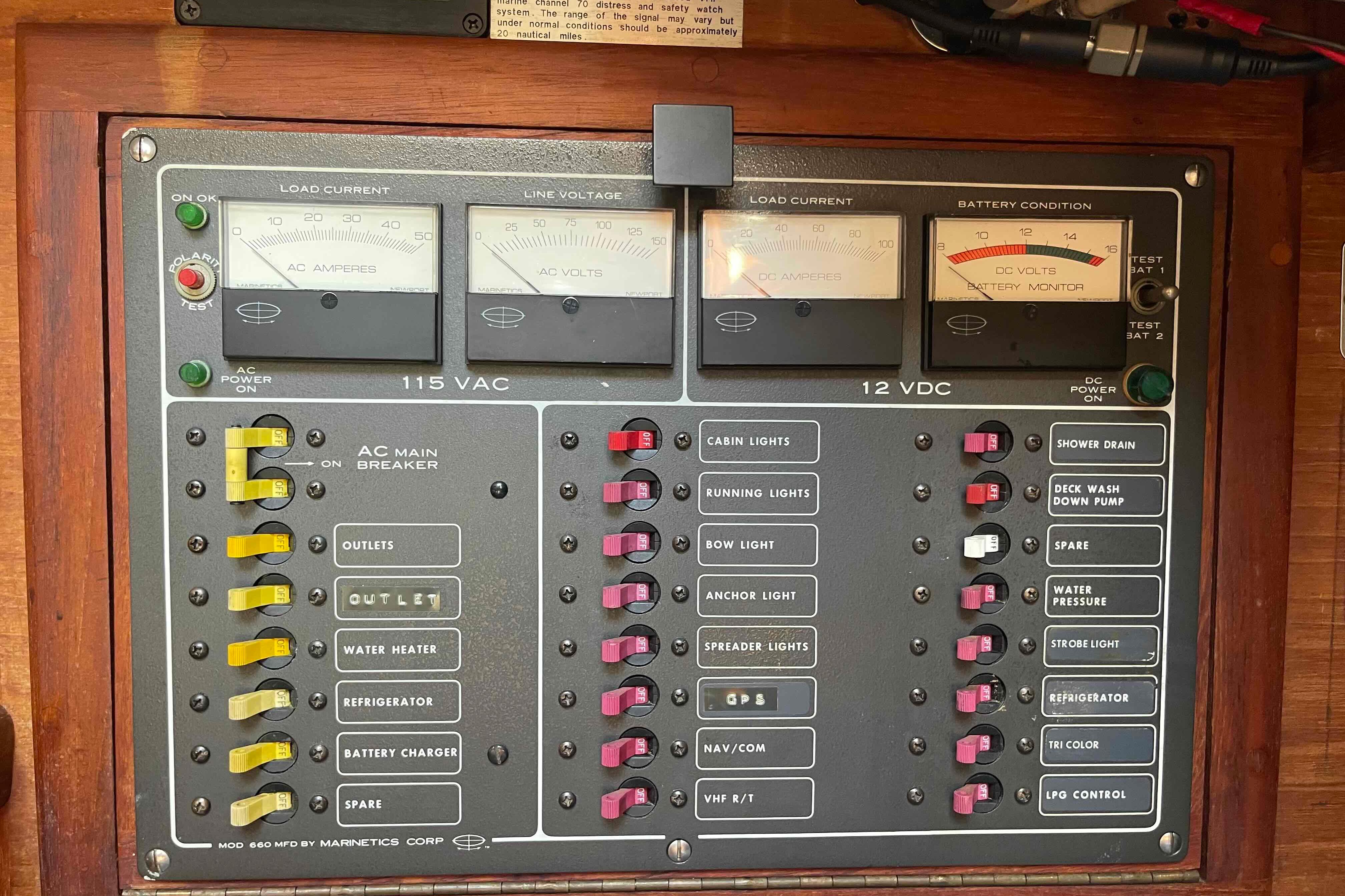 Electrical control panel on a 1987 Pacific Seacraft 34 sailboat, featuring AC and DC systems.