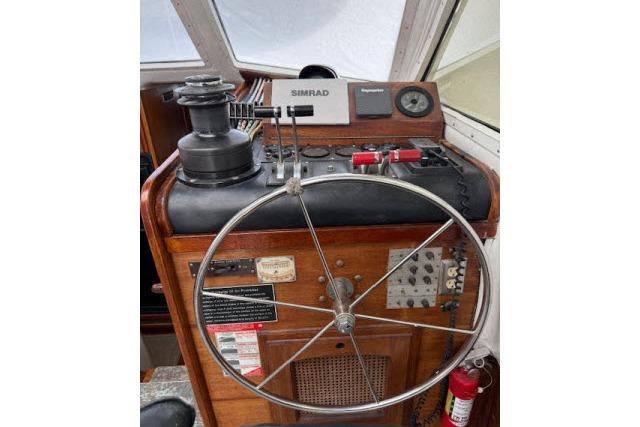 Helm of 1982 Lancer 45 Motorsailer with steering wheel and navigation controls.