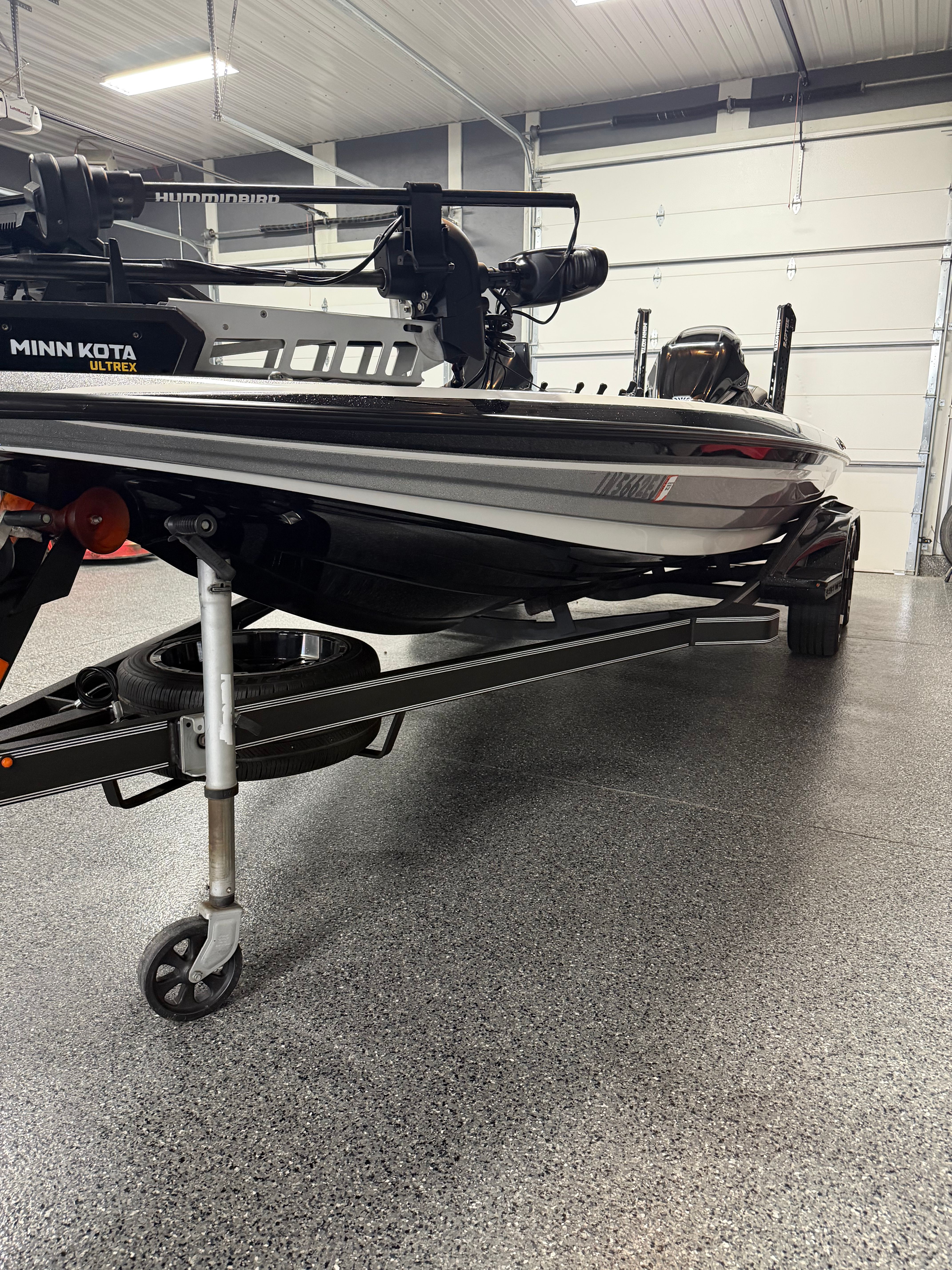 A Skeeter FXR21 Limited boat in a garage on a trailer.