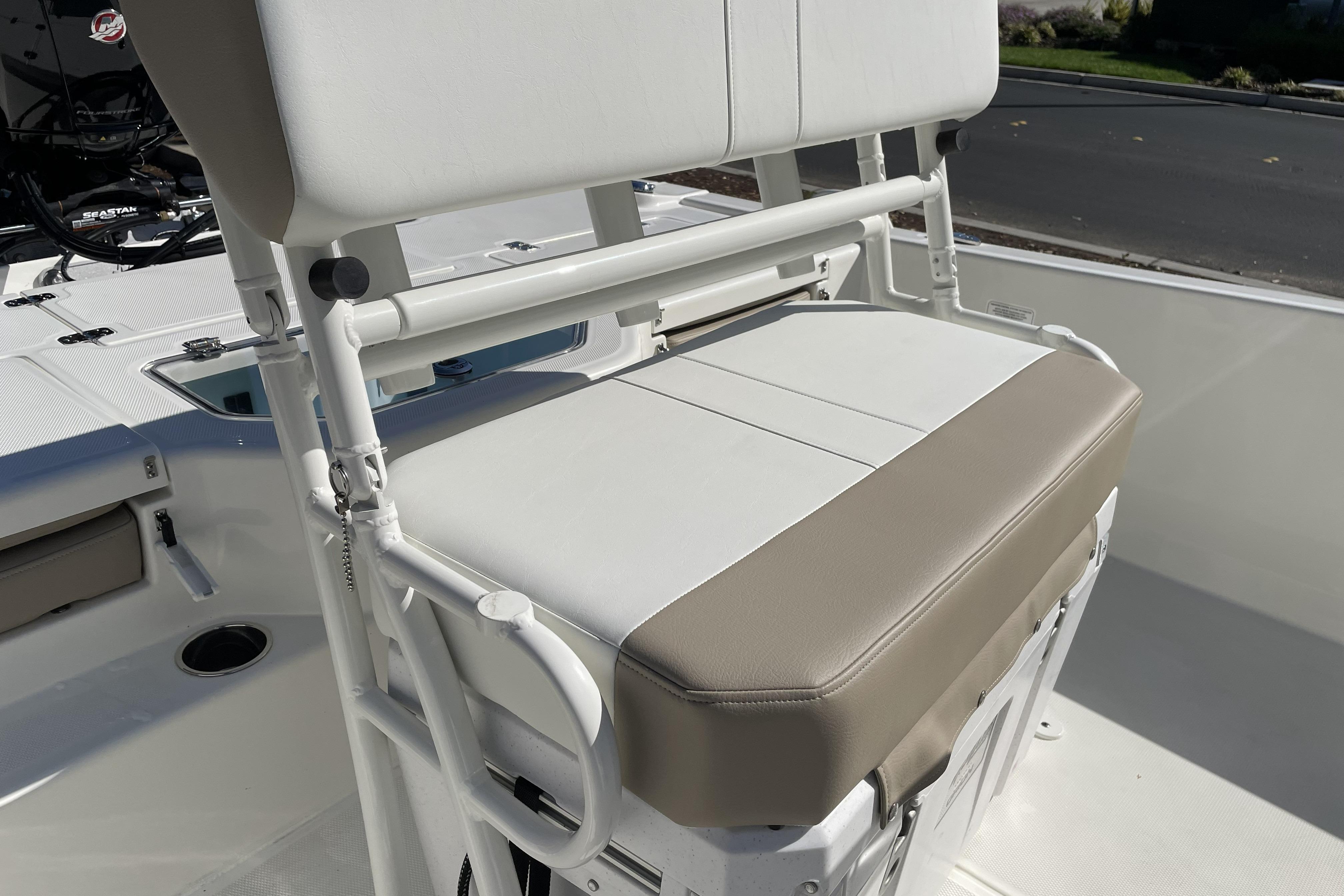2026 Mako Pro Skiff 19 CC boat seat with white and beige upholstery.
