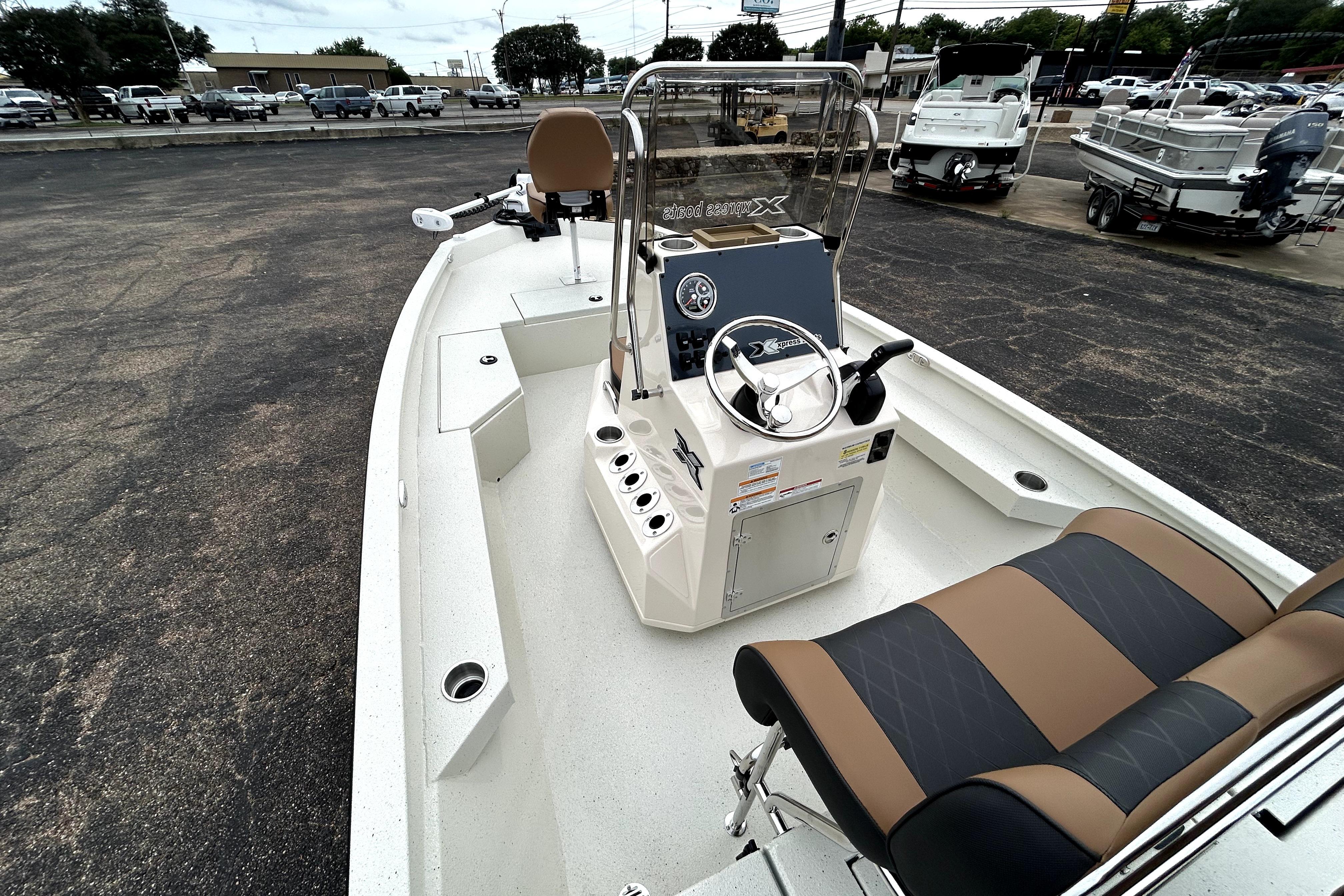 2026 Xpress H20B Bay boat interior with steering console and seating.