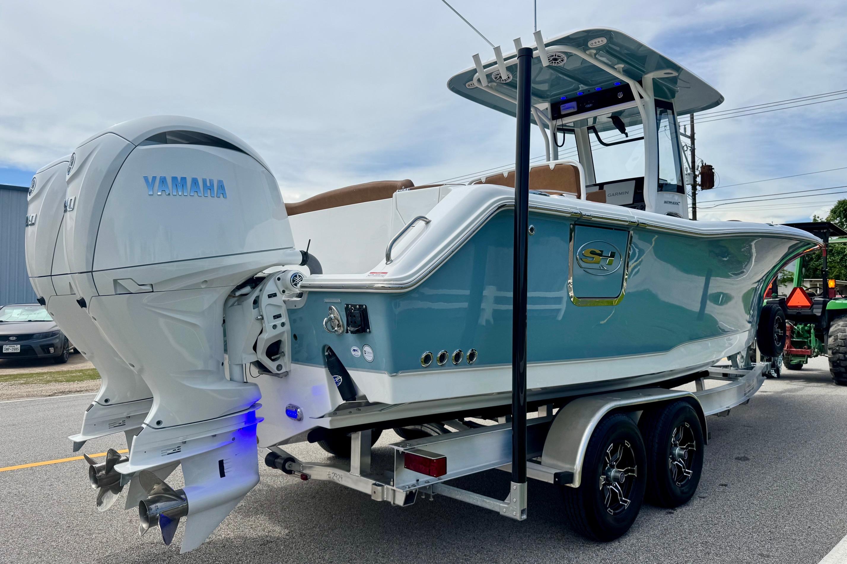 2026 Sea Hunt Ultra 275 SE boat with dual Yamaha engines on a trailer.