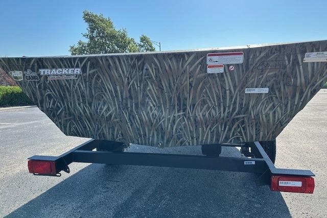 2026 Tracker Grizzly 1648 Utility boat with camo design on a trailer.
