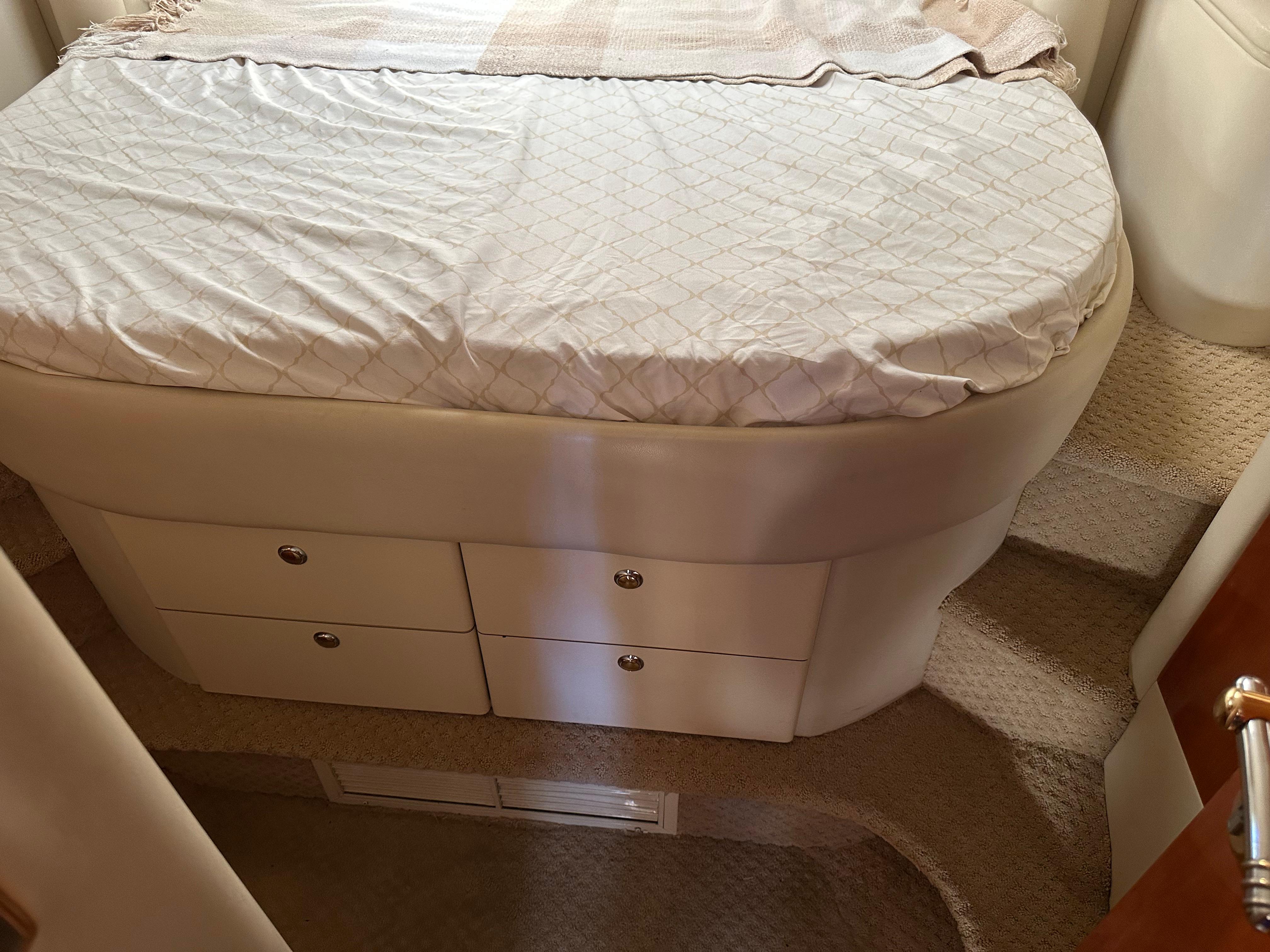 Interior cabin of 1997 Sunseeker Camargue 47 with bed and storage drawers.