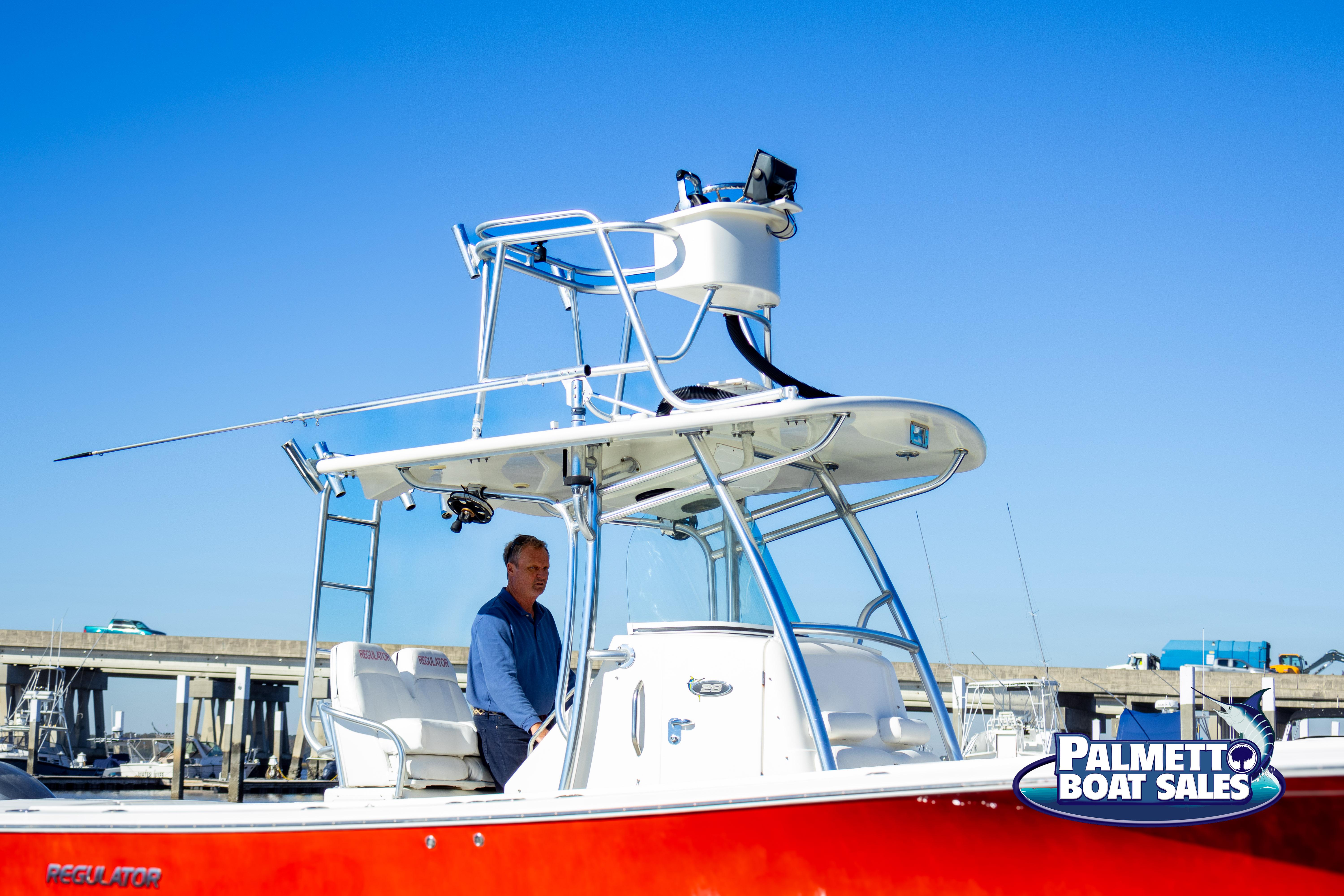 2011 Regulator 28 boat with red hull at Palmetto Boat Sales.