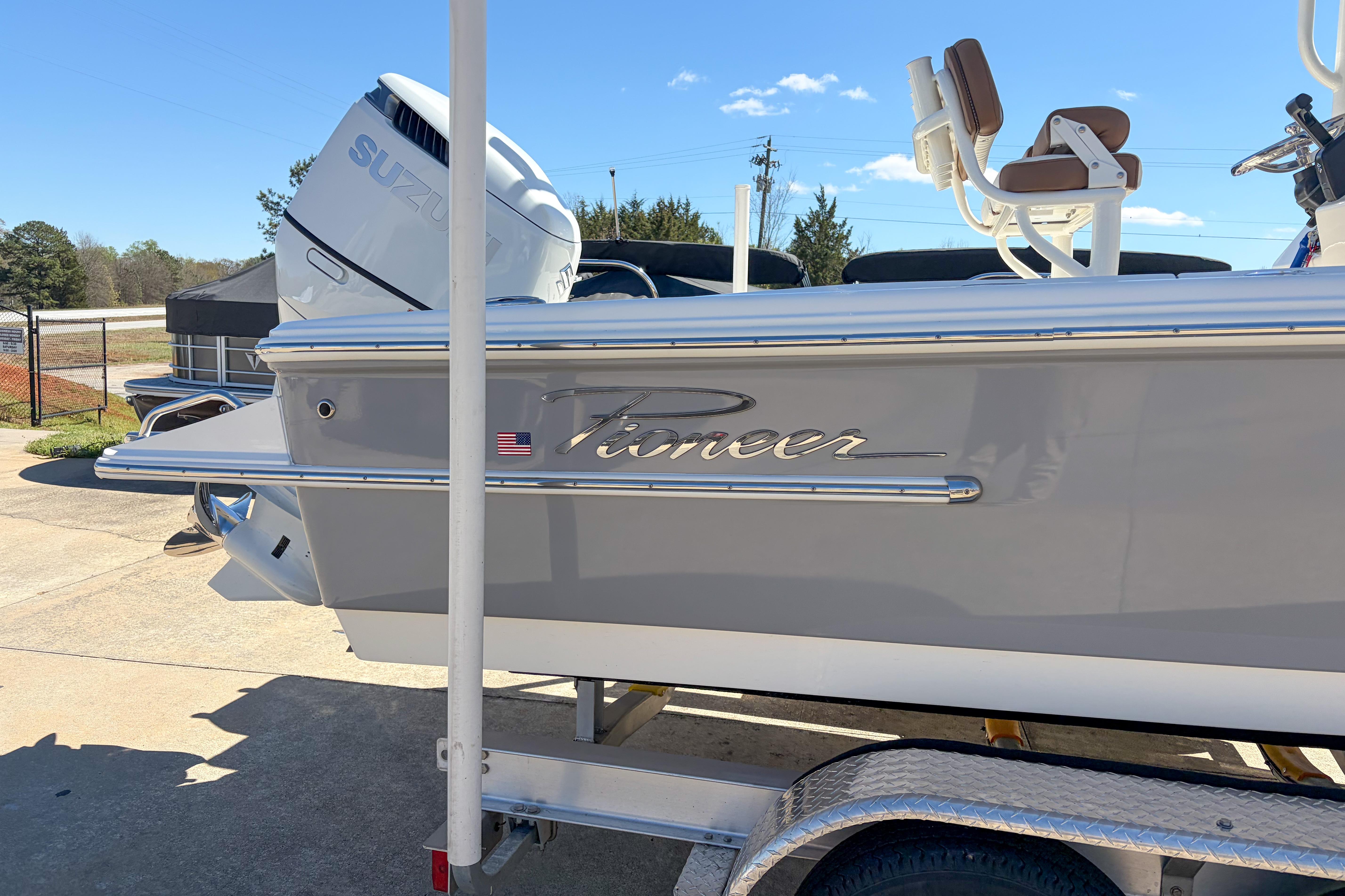 2026 Pioneer 220 Bay Sport boat with Suzuki engine on trailer.