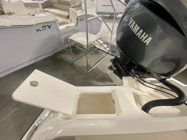 2024 Key West 219 FS boat with Yamaha engine, open storage compartment.