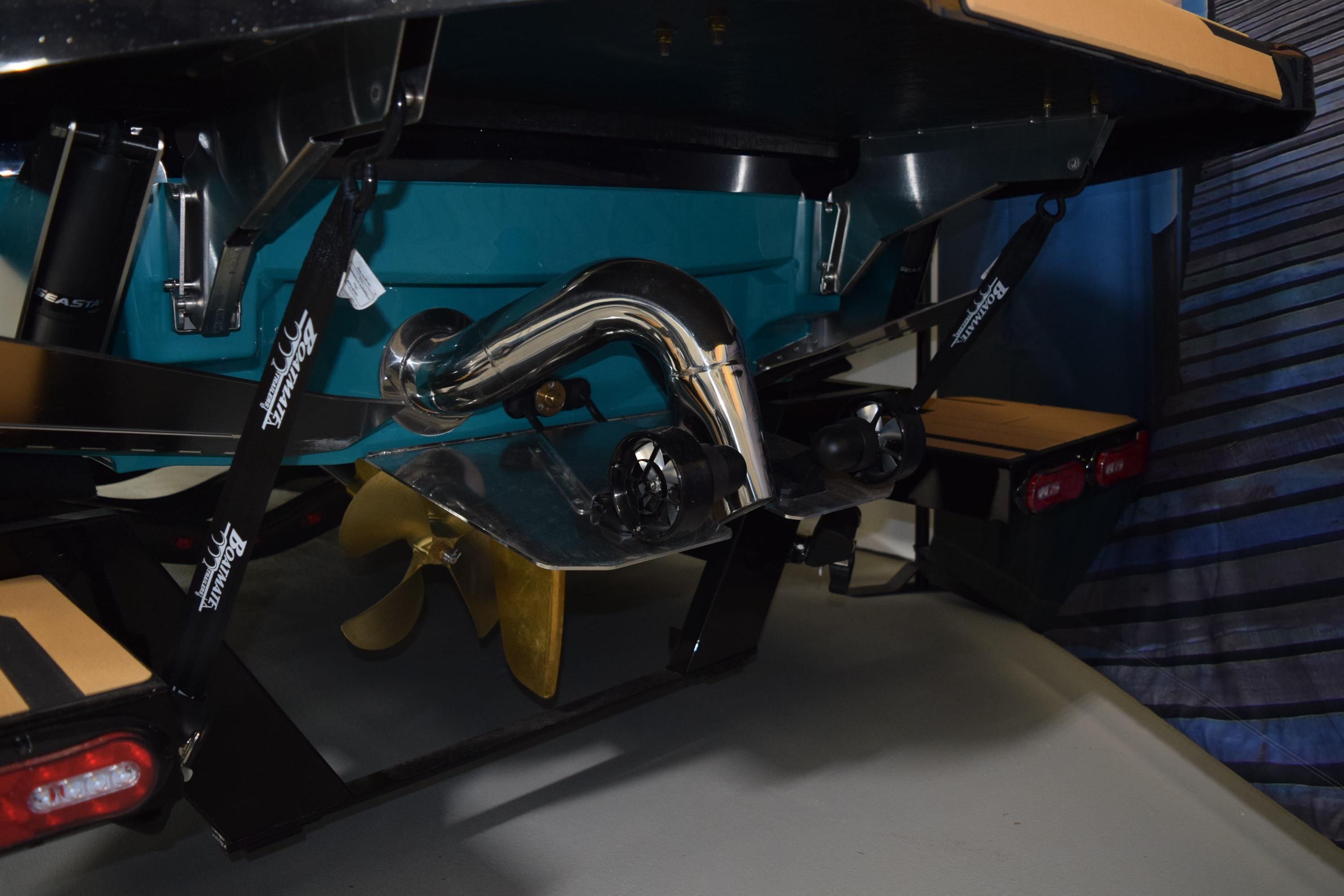 2026 Supra SL 550 boat propeller and exhaust system close-up.