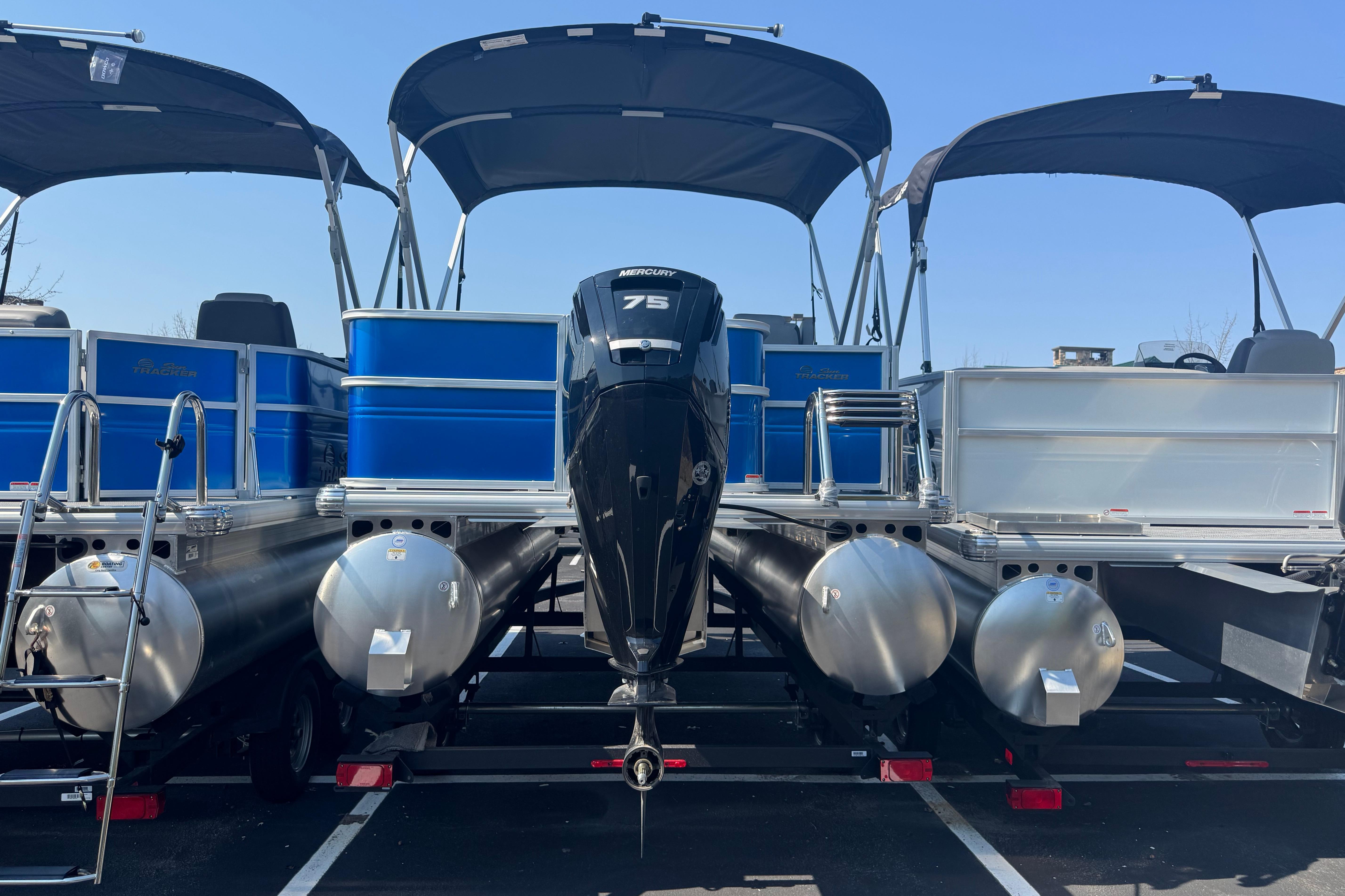 2026 Sun Tracker Party Barge 18 DLX pontoon boats with Mercury 75 engines, parked side by side.