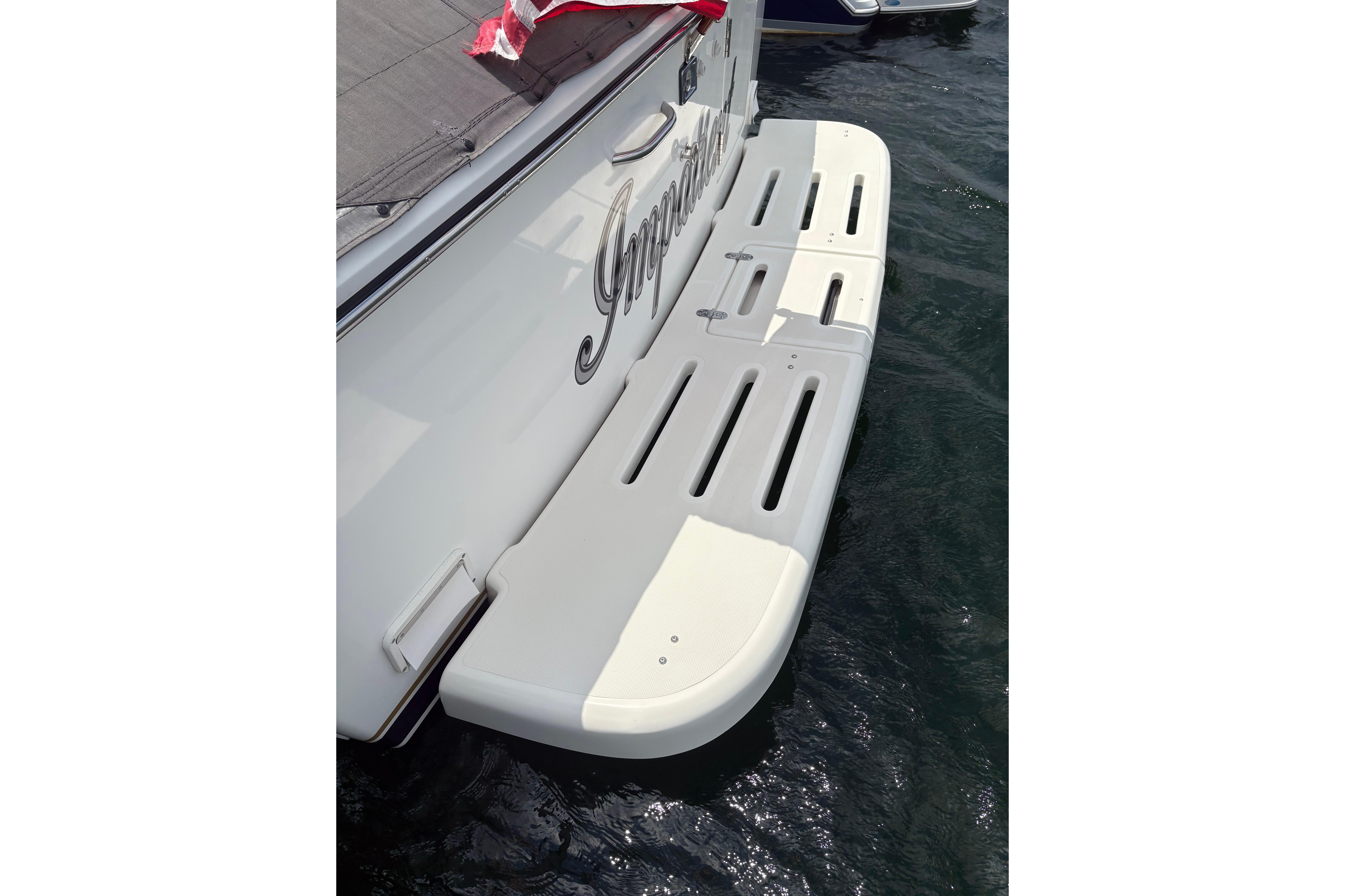 1999 Tiara Yachts 3100 Open swim platform on water, showcasing sleek design.
