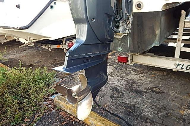 2003 World Cat 270 EC boat with visible outboard motor and propeller.