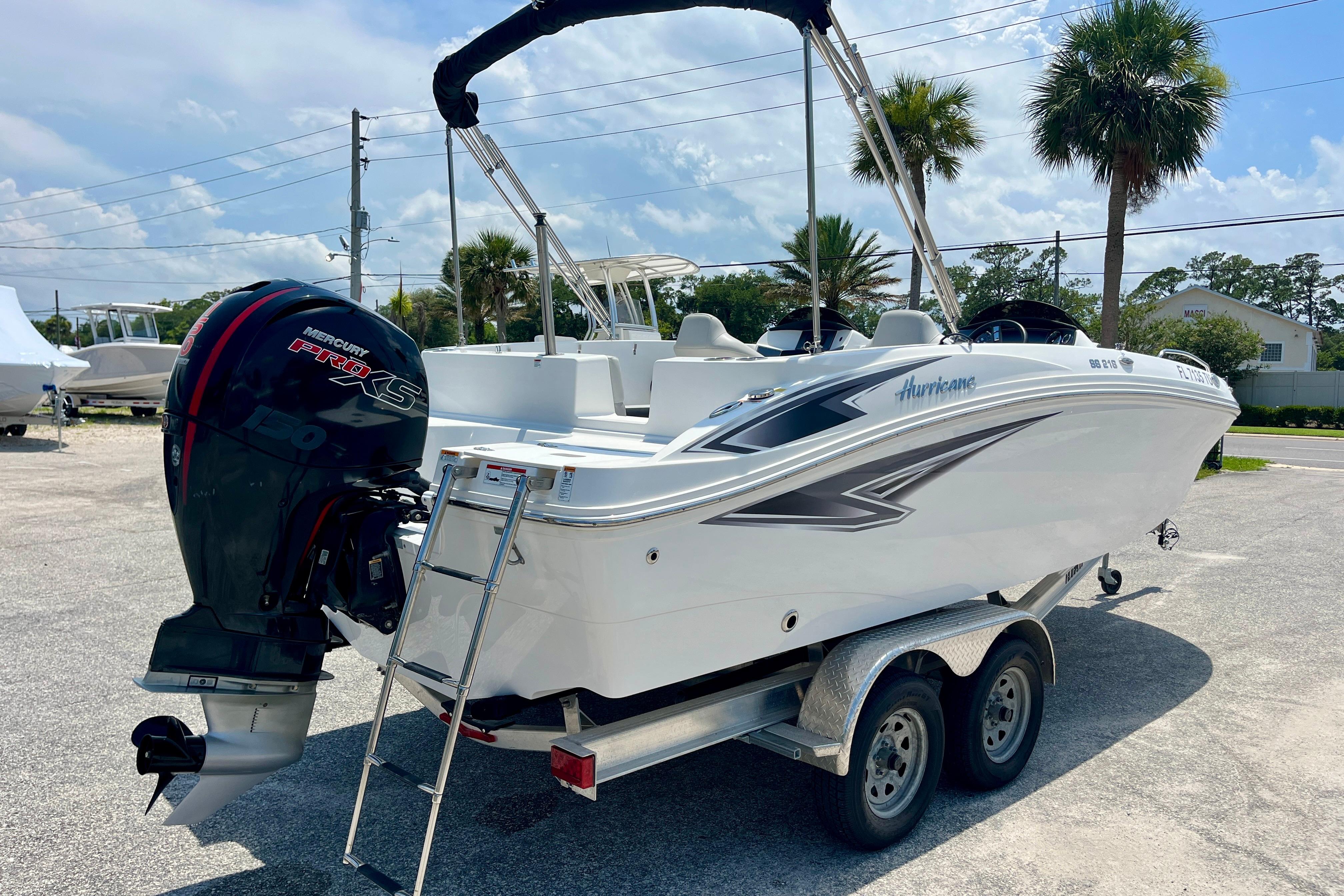 2024 Hurricane Sundeck Sport 218 OB boat on trailer, featuring Mercury Pro XS engine.