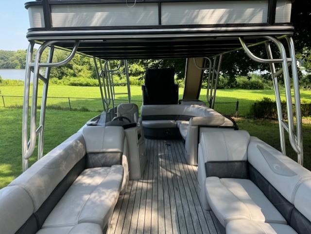2017 Crest Caribbean 250 L pontoon boat with spacious seating and scenic lake view.
