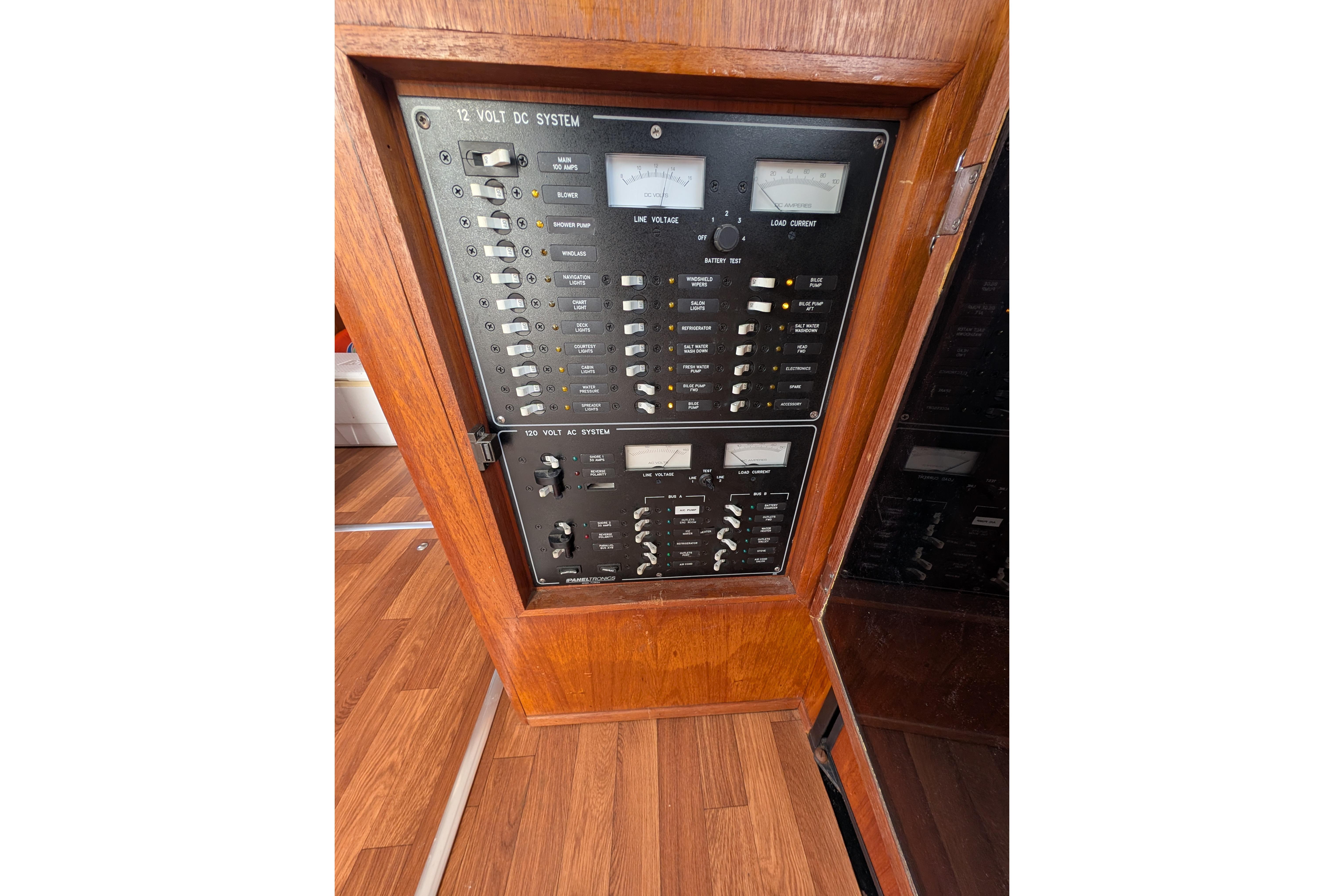 Electrical control panel on a 1998 Markley 46 boat, featuring 12V and 120V systems.
