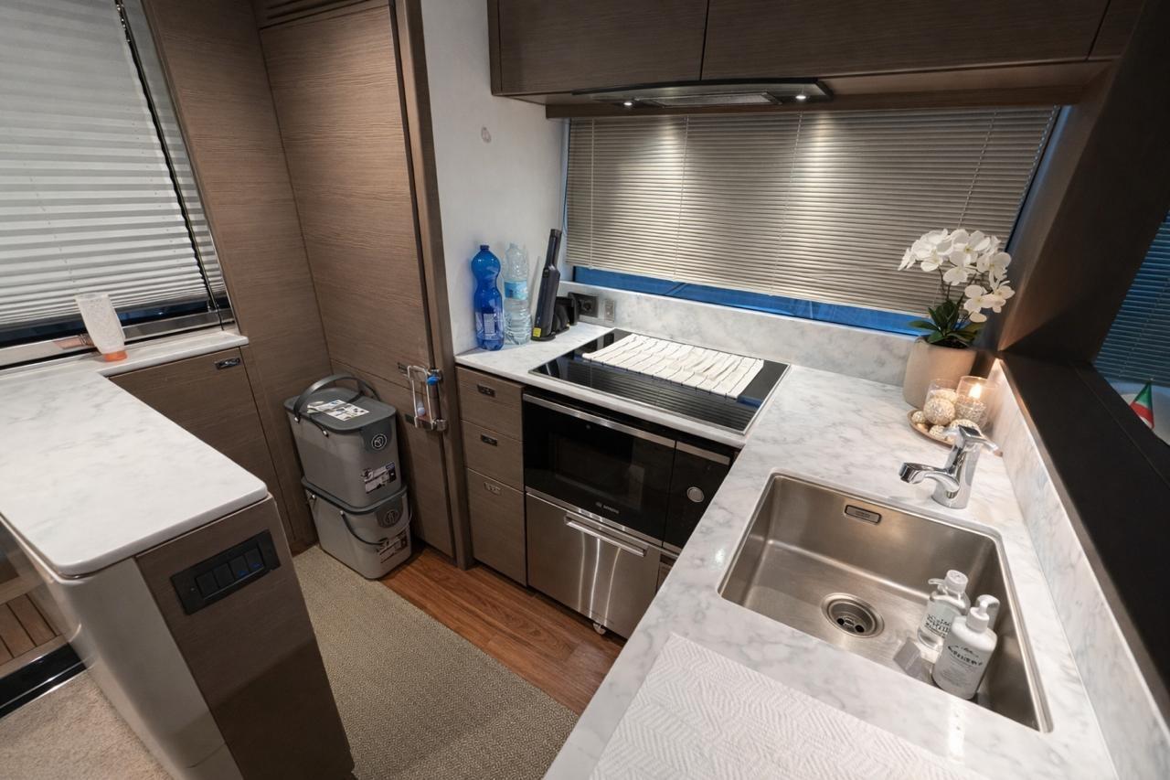 Modern kitchen interior on 2022 Princess S62 yacht with sleek countertops and stainless steel appliances.