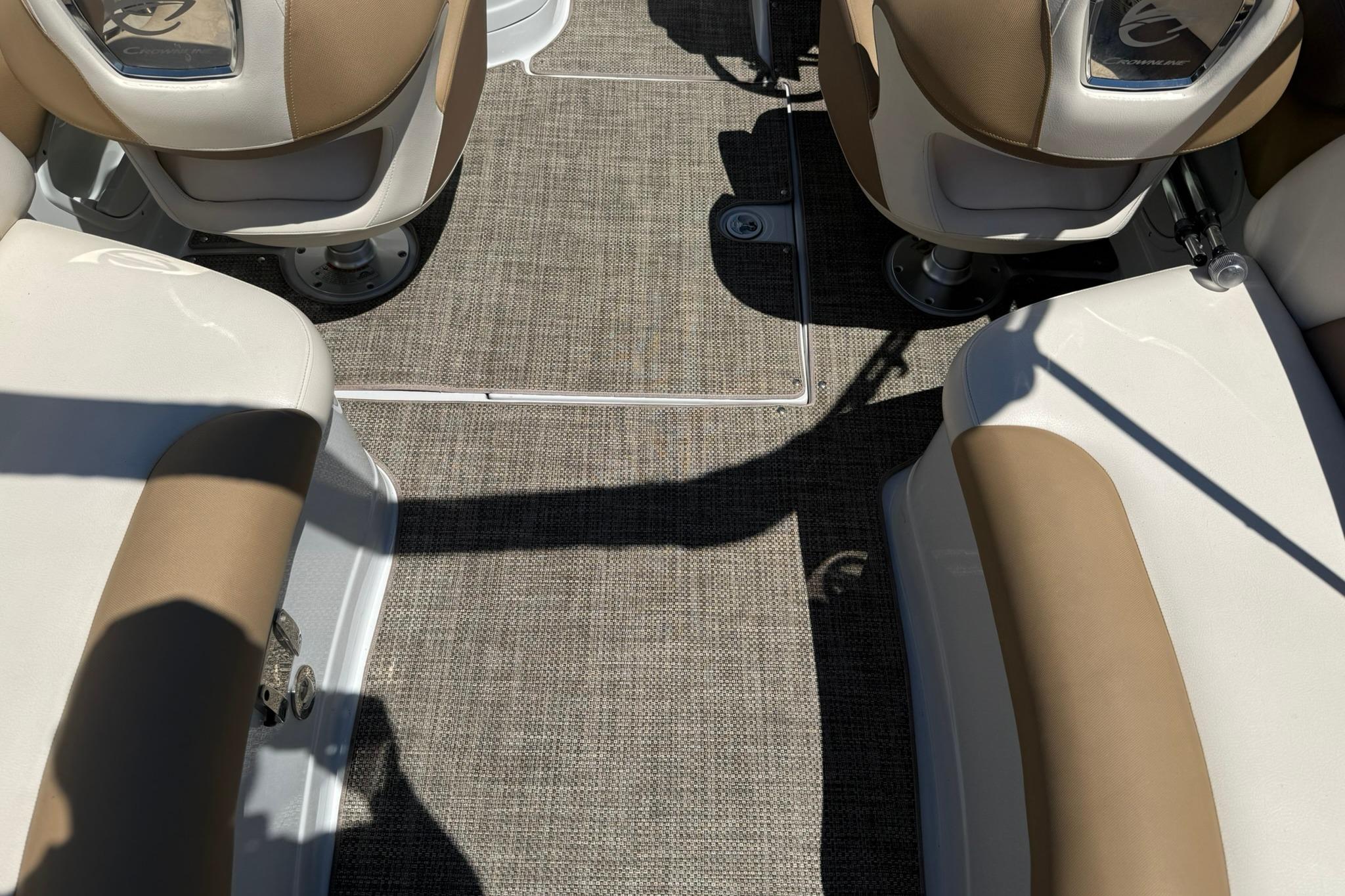 Interior view of a 2016 Crownline 255 SS boat with beige and white seating.