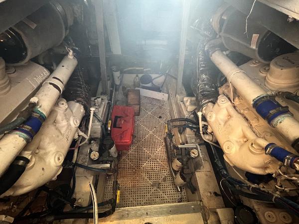 Engine room of 1985 Hatteras 45 Convertible boat, showing dual engines and equipment.
