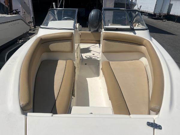 2019 Scout 210 Dorado boat with beige seating and dual consoles.
